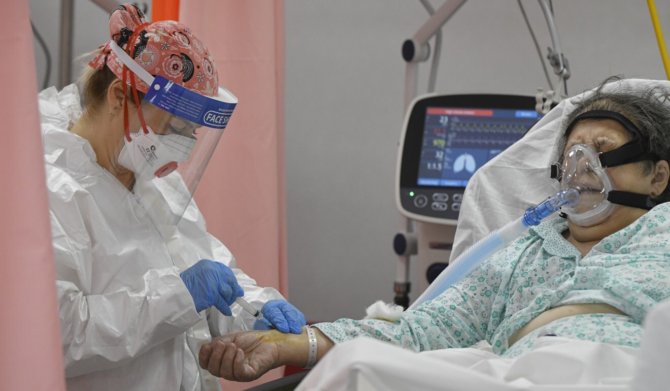 A woman breathing through an oxygen mask gets an injection in the emergency room, turned into a Covid-19 unit, at a hospital in Bucharest on Tuesday. Photo: AP