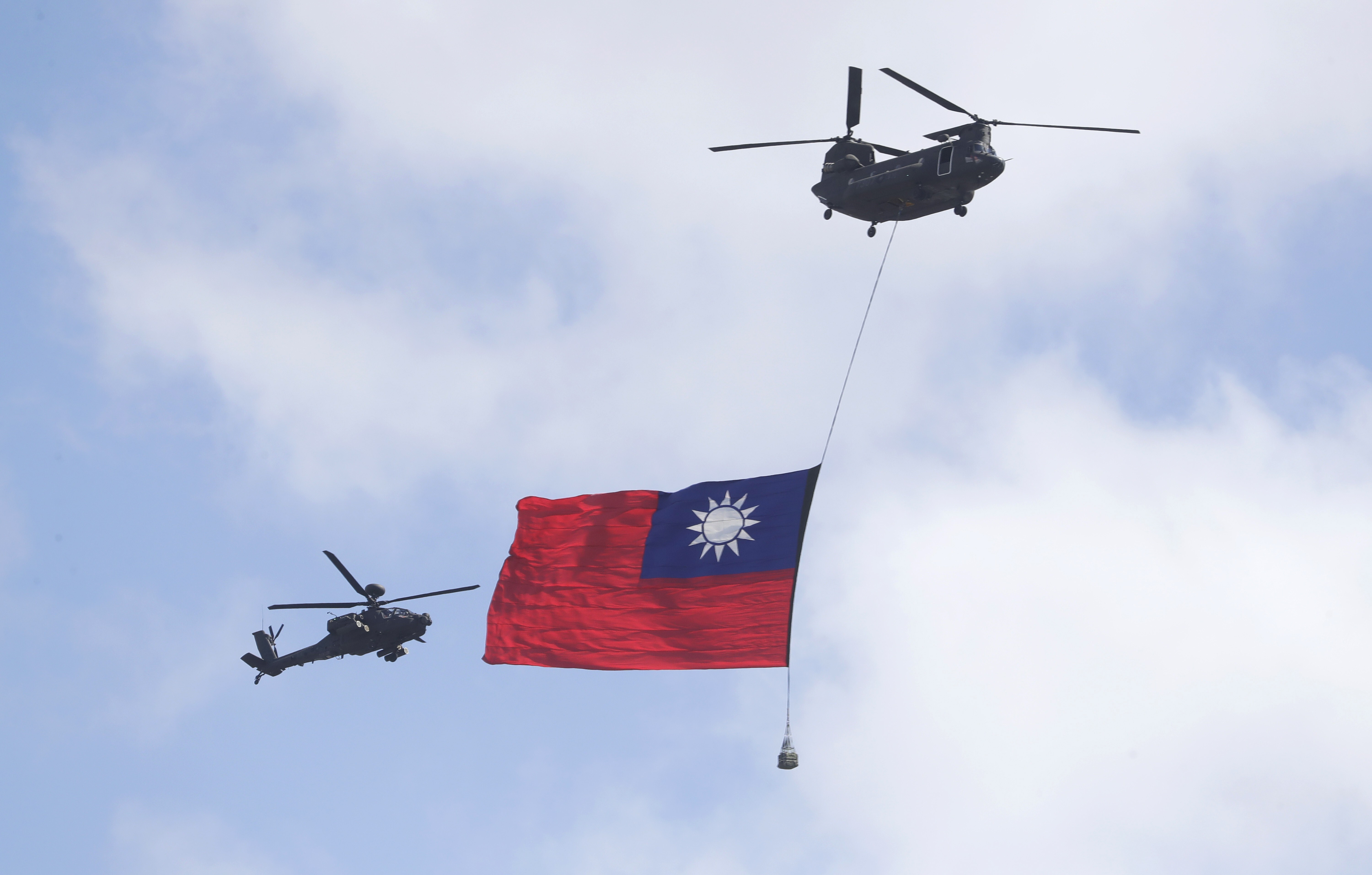 Helicopters fly in front of the presidential building in Taipei on Sunday, the Double Tenth holiday. Photo: AP