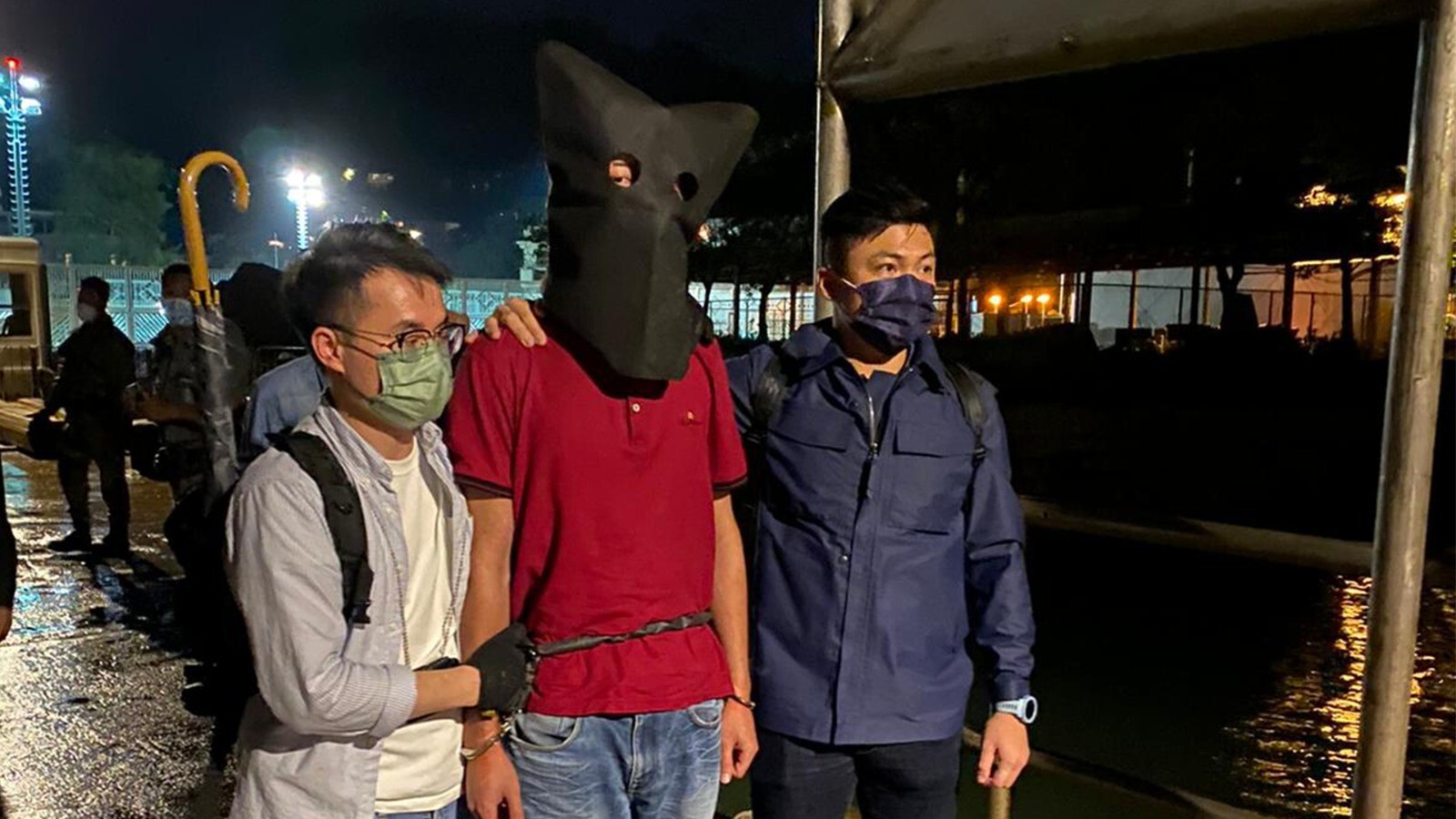 Hong Kong police with the murder suspect in custody. Photo: Handout