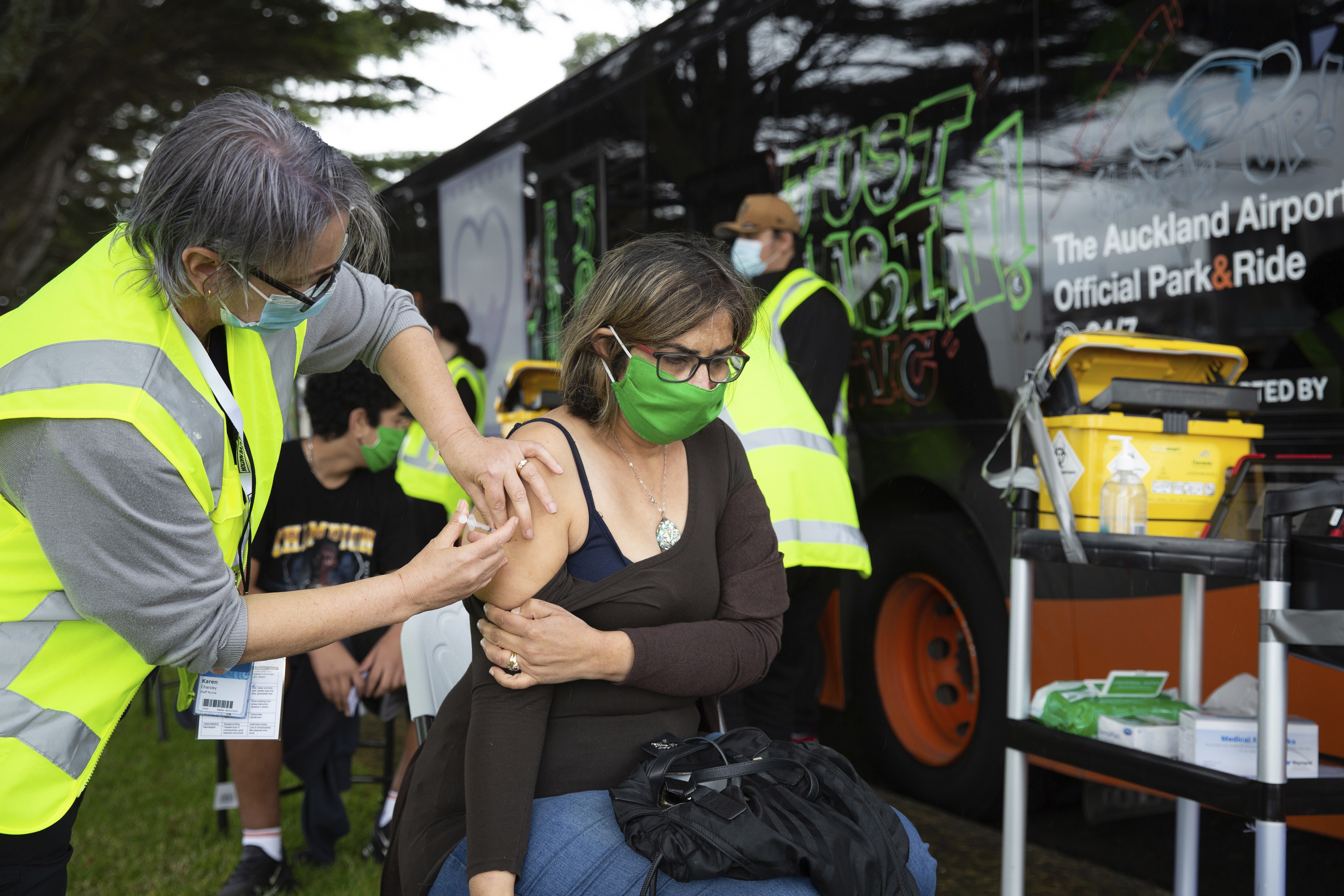 A woman receives a vaccination against Covid-19 at a mobile clinic in Auckland. Photo: NZ Herald via AP
