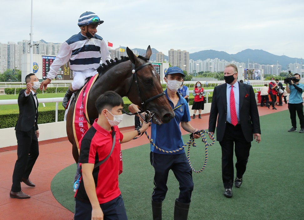 Trainer Tony Millard looks over the victorious Panfield.