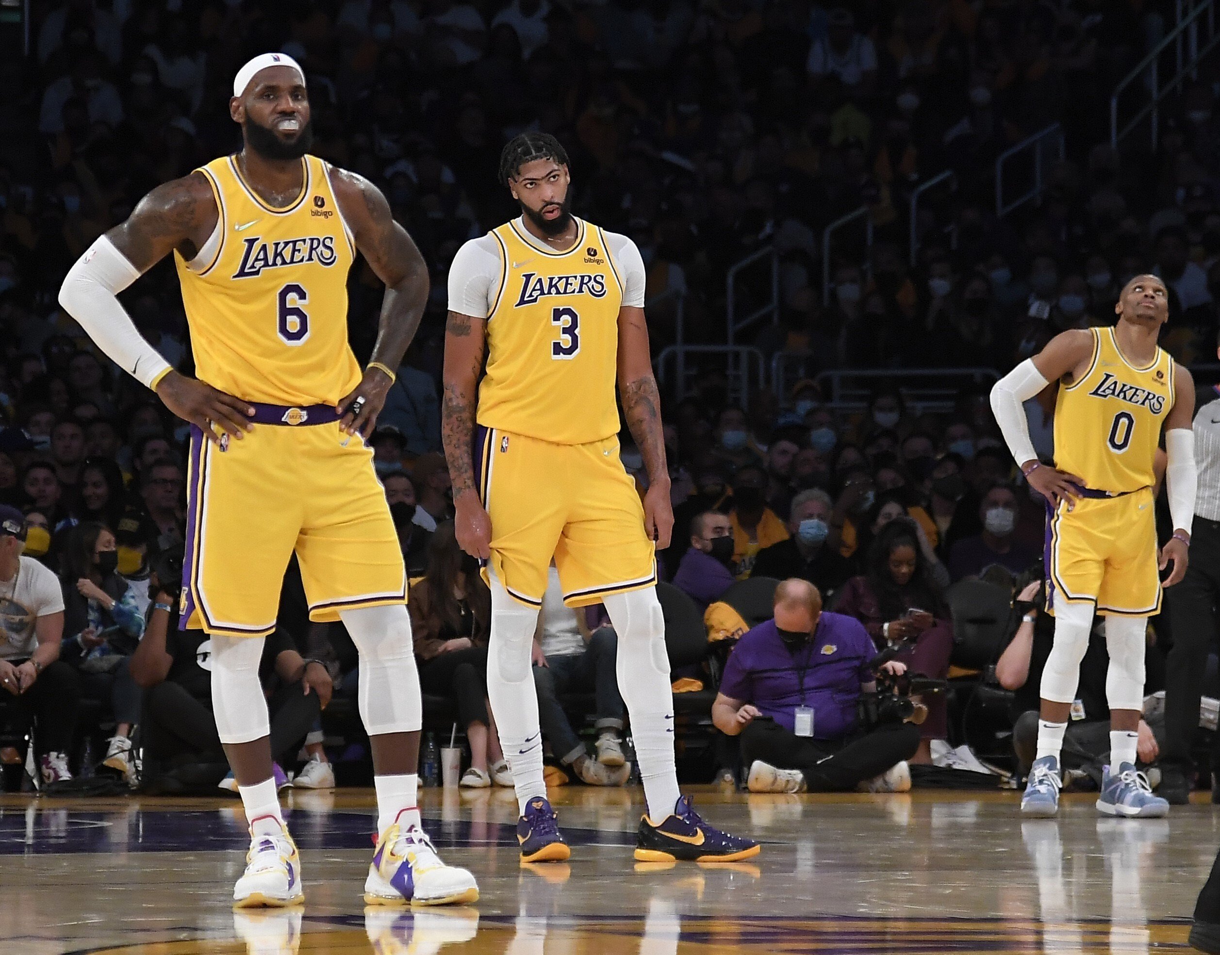 LeBron James (left), Anthony Davis (centre), and Russell Westbrook of the Los Angeles Lakers react during the second half of their 2021-22 NBA season opener against Golden State Warriors. Photo: AFP