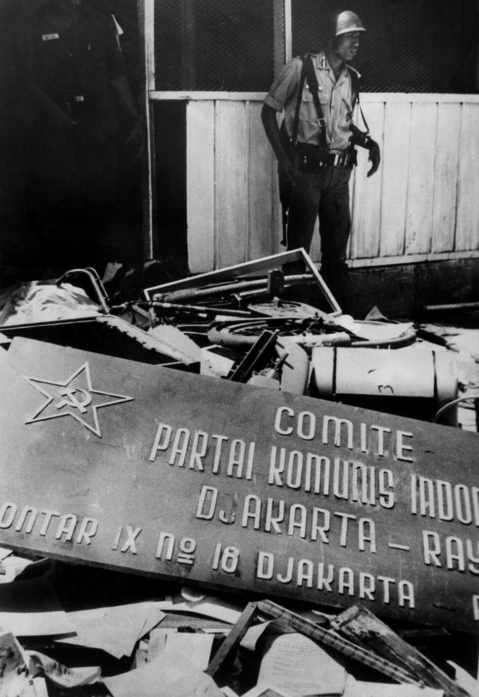 Protesters destroy an office of the Indonesian Communist Party in 1965. Photo: AFP