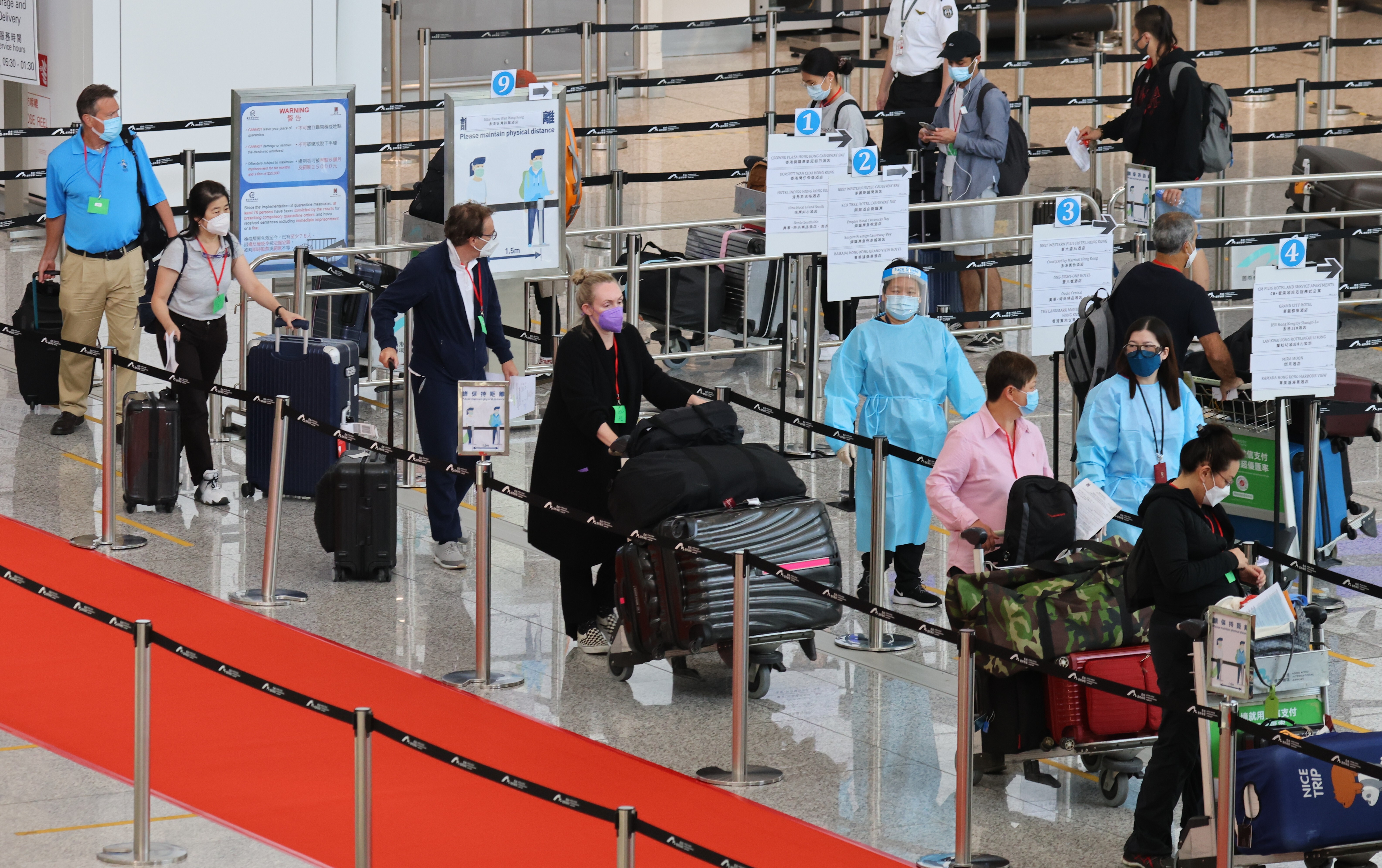 Inbound travellers arriving at Hong Kong International Airport getting in queue to be transported to quarantine hotels in the city on 2 September 2021. Photo: Dickson Lee