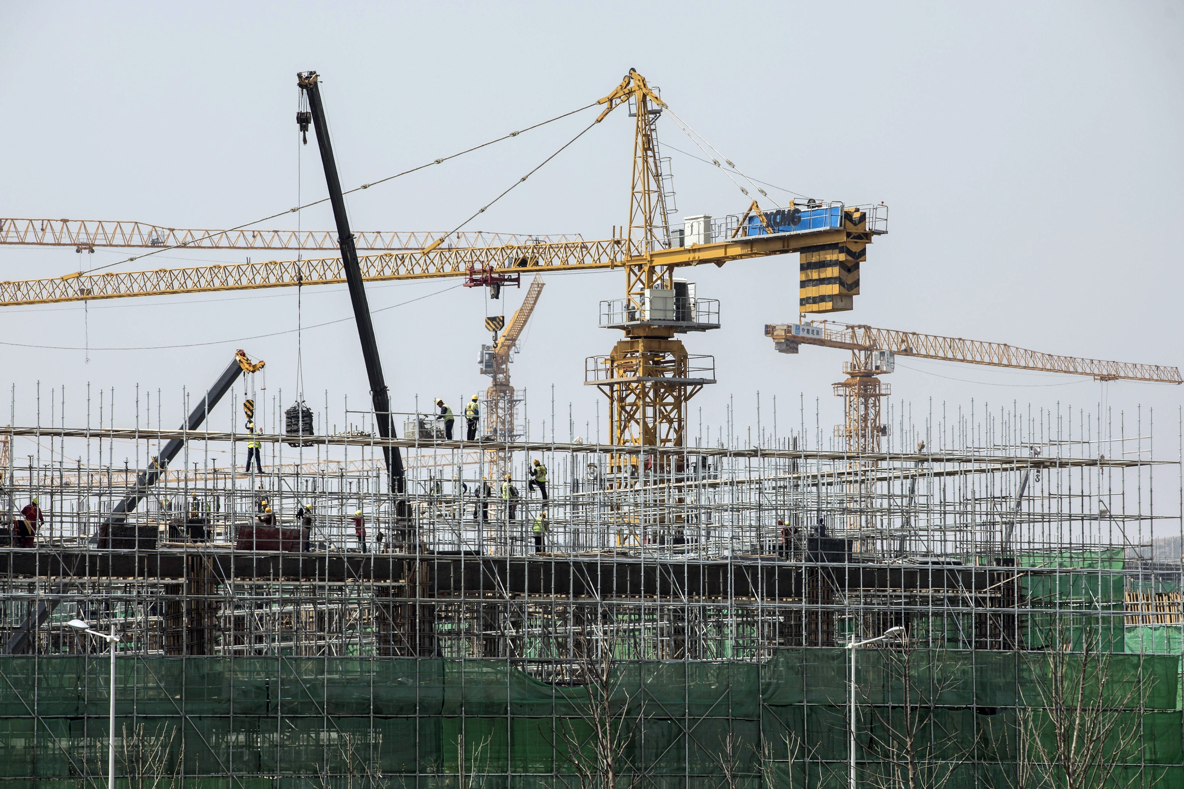 Cranes operate at residential buildings under construction at Dalian Wanda’s Oriental Movie Metropolis film production hub in Qingdao, China, in April, 2018. Photo: Bloomberg