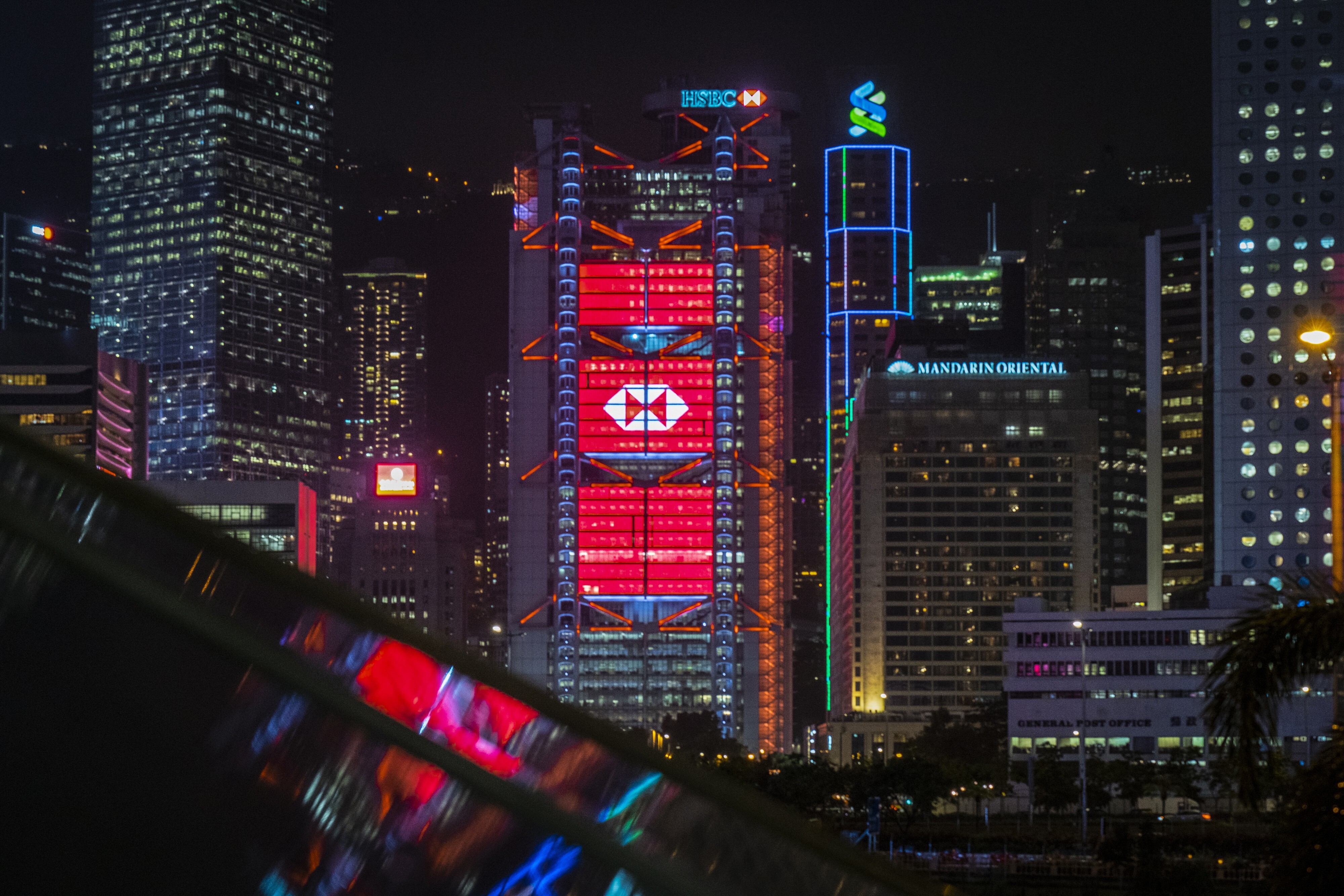 The HSBC and Standard Chartered buildings are illuminated in Hong Kong. HSBC kicks of the third-quarter earnings season on Monday. Photo: Bloomberg