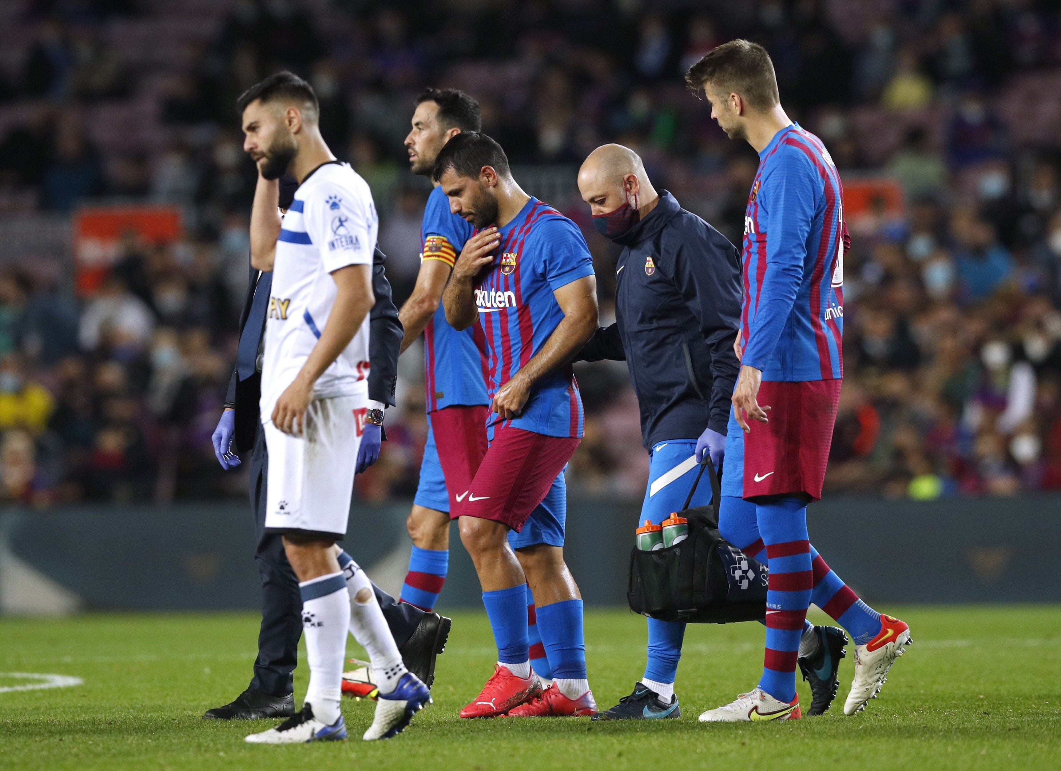 Barcelona’s Sergio Aguero leaves the pitch after complaining of chest pains. Photo: Reuters