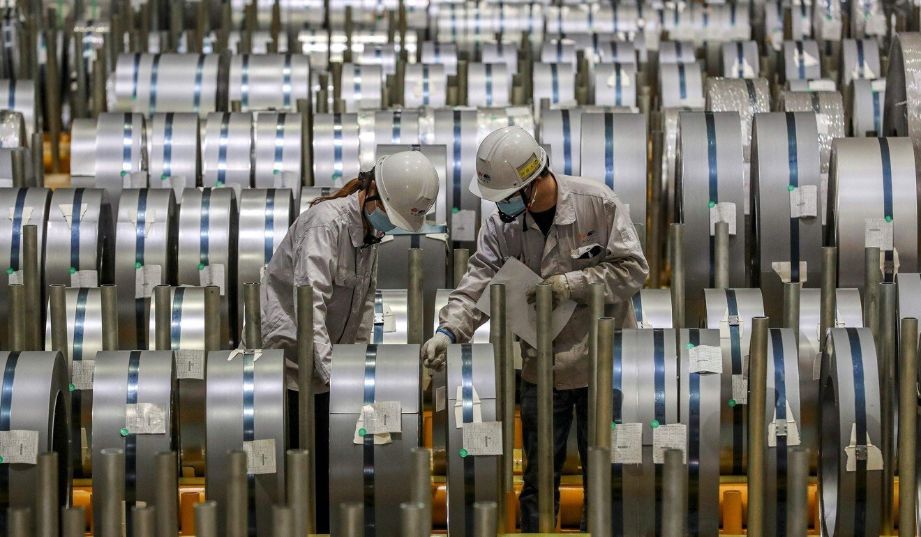 Workers check rolls of sheet aluminium at a factory in Wuhan, in China’s central Hubei province. Photo: AFP