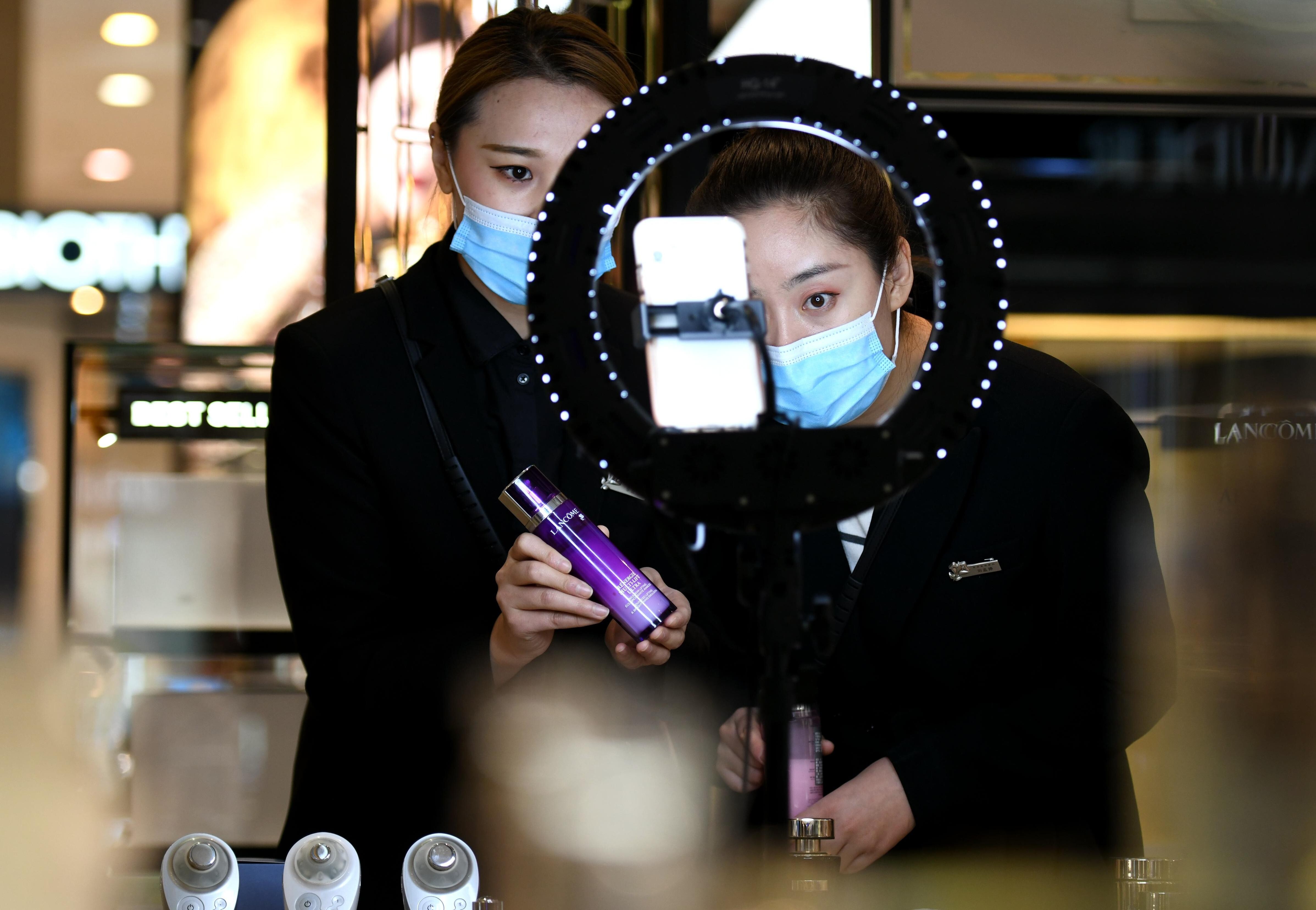 Saleswomen use live-streamed marketing campaigns to help drive demand for cosmetic products at a shopping centre in northern China’s Hebei province. Photo: Xinhua
