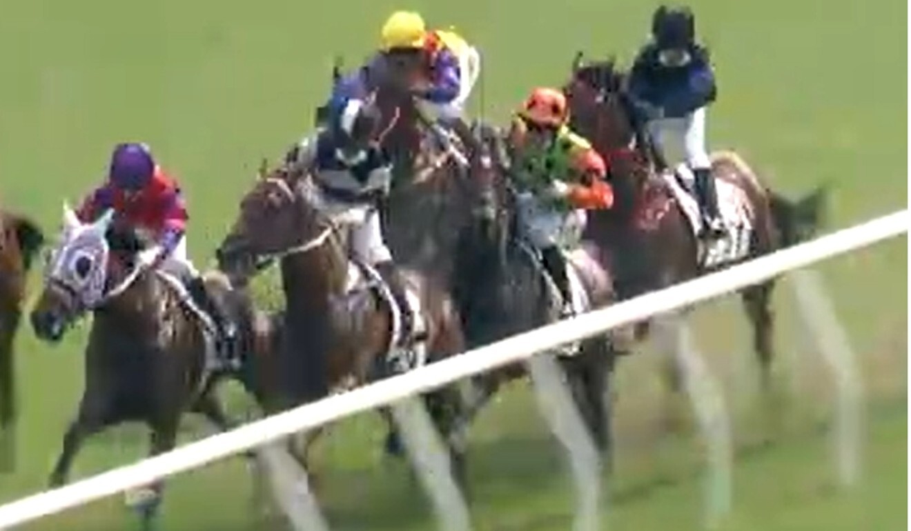 Carroll Street (green and orange silks) narrowly avoids going through the rail.