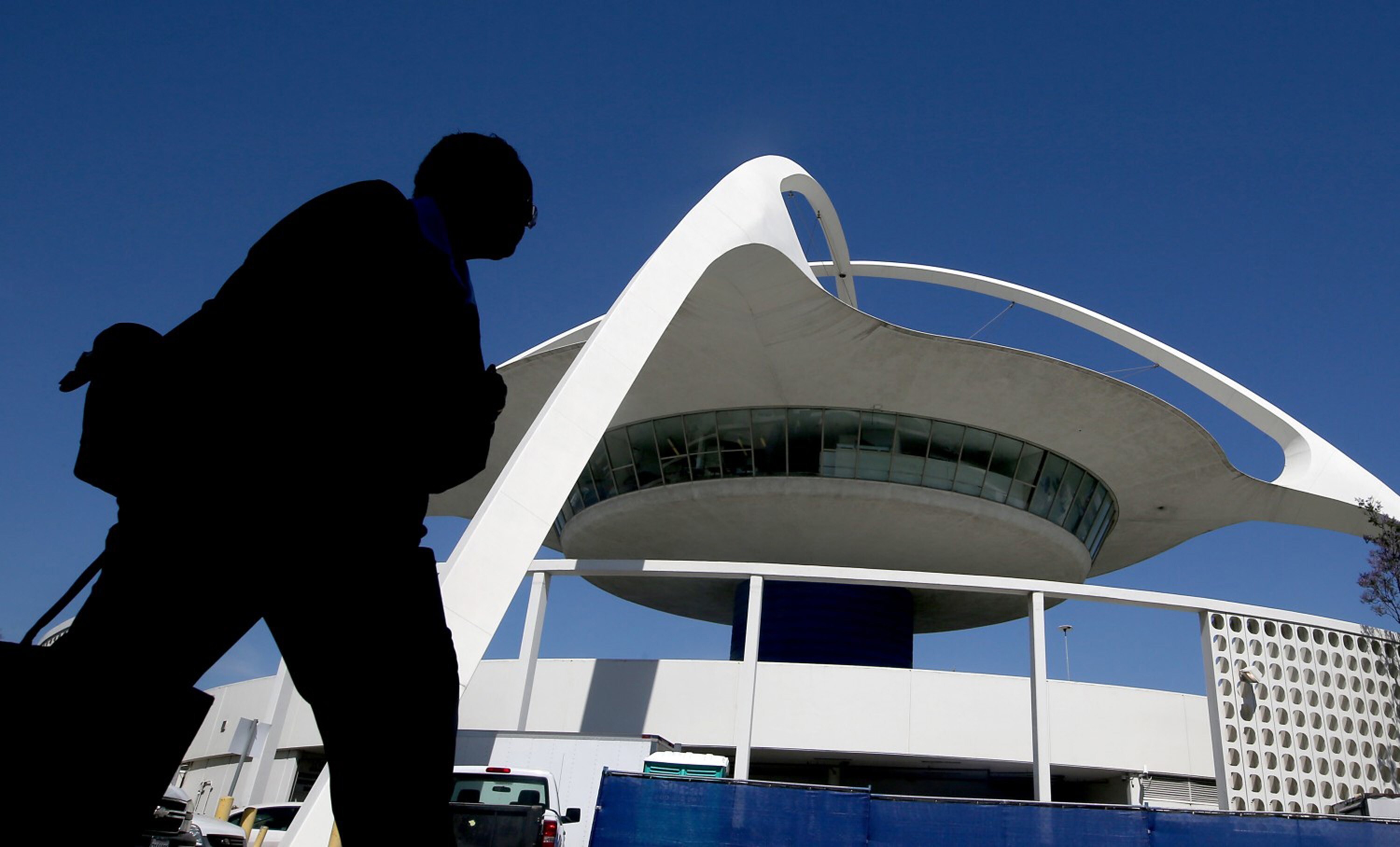 A pedestrian walks past the Theme Building between Terminals 2 and 6 at Los Angeles International Airport in 2017. Photo: TNS