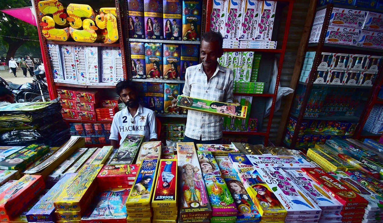 Indian vendors sell firecrackers at a market in Allahabad on October 31, 2021. Photo: AFP