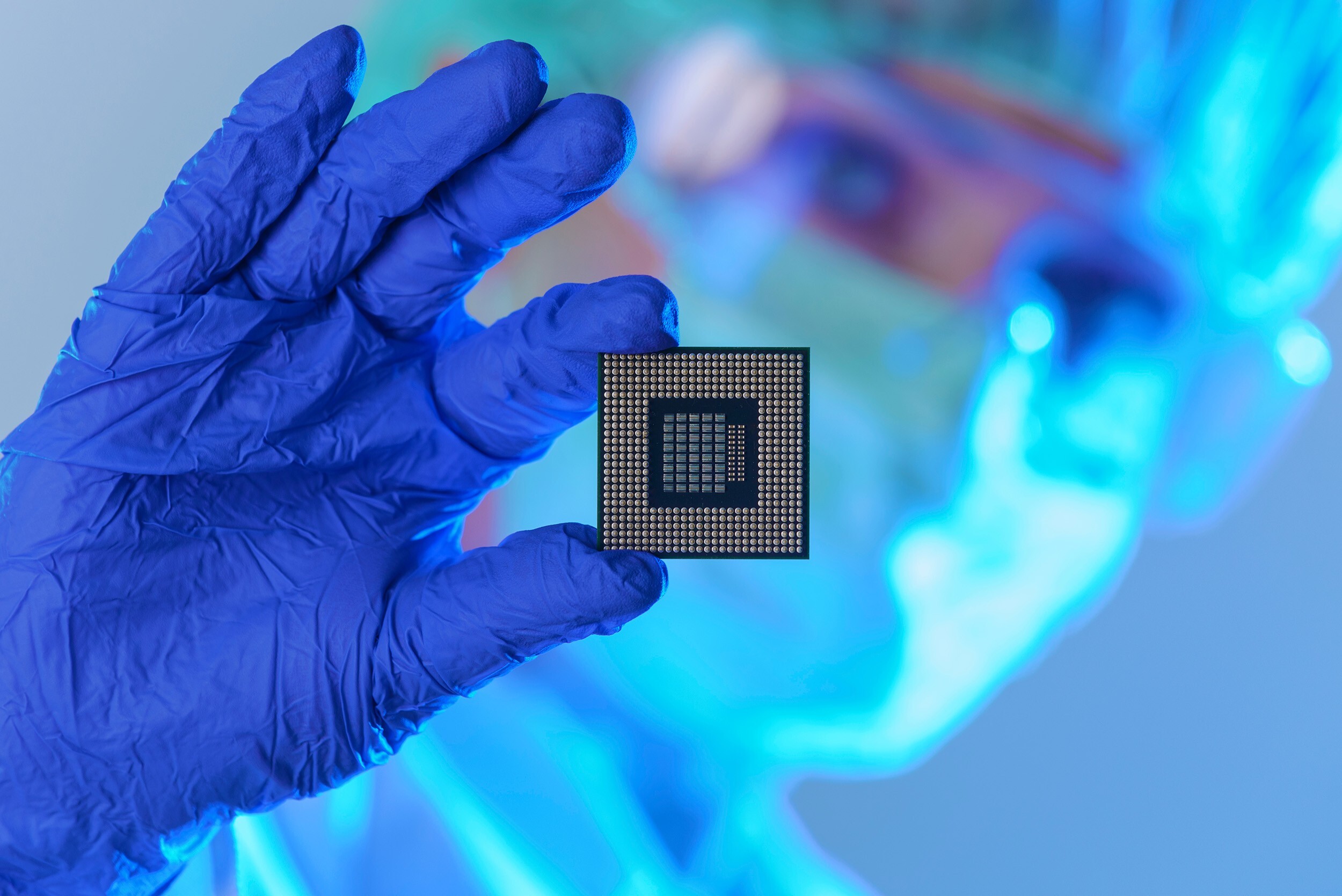 A laboratory engineer inspects a computer chip. Photo: Shutterstock