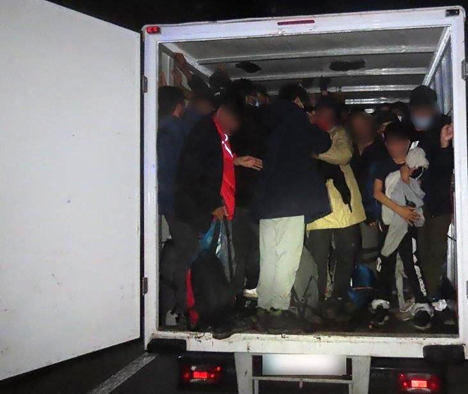 A group of migrants smuggled in a truck at an unknown location. Photo: Europol /AFP
