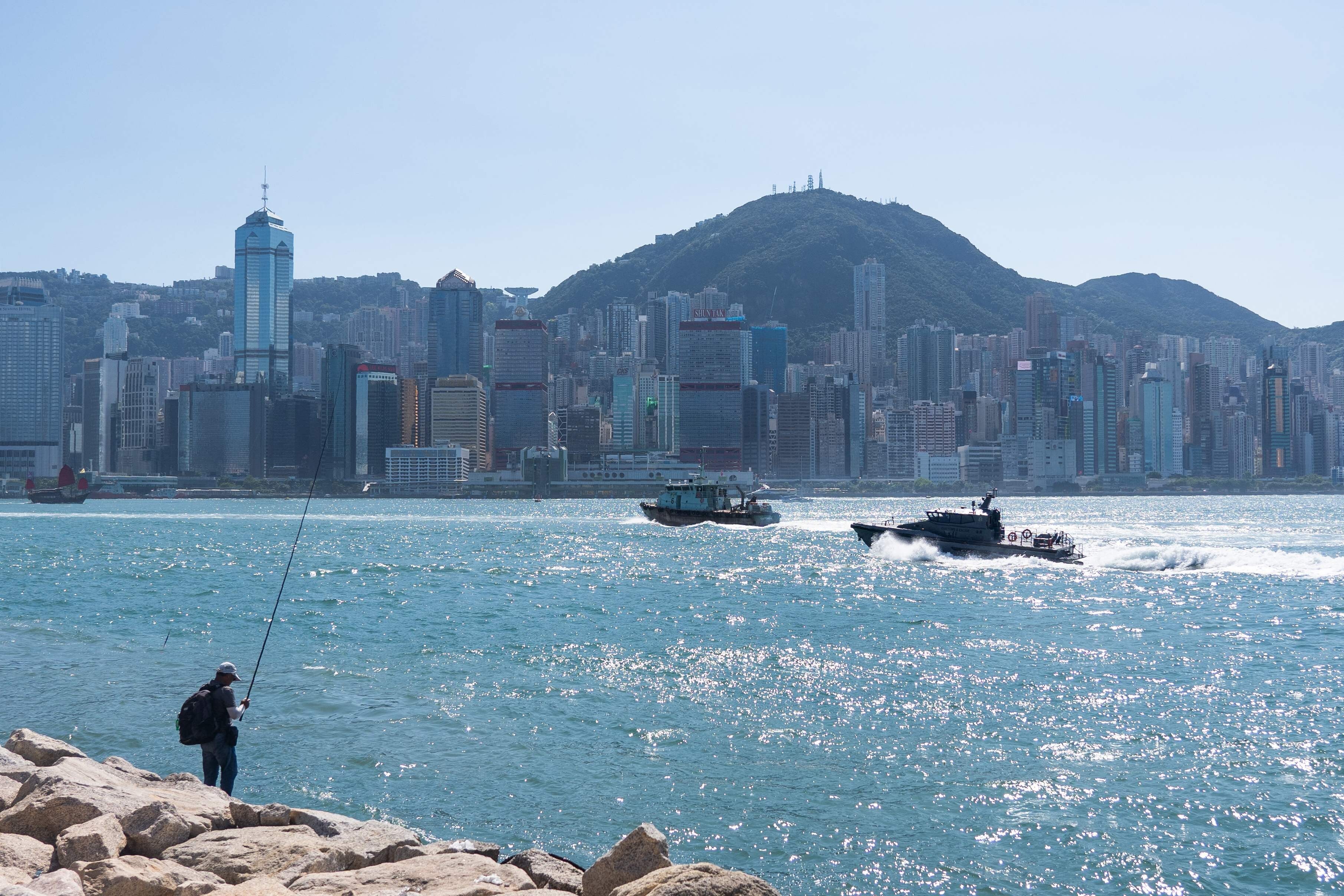 An angler tries his luck at the harbourfront in Hong Kong on Saturday. Photo: AFP