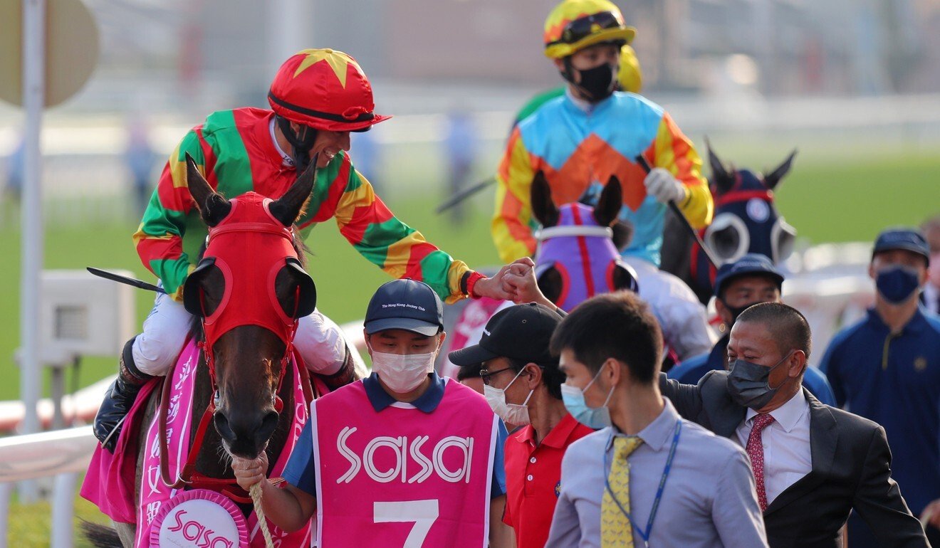 Jockey Alexis Badel and trainer Danny Shum celebrate Tourbillon Diamond’s victory.