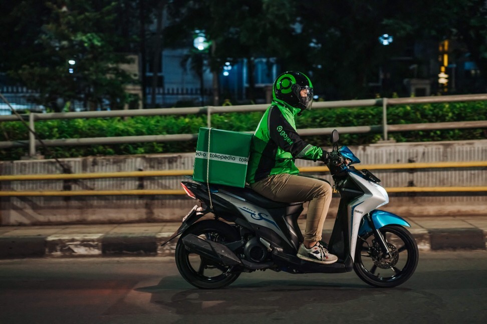 A Gojek rider delivering a Tokopedia package to a customer in Jakarta. Photo: AFP