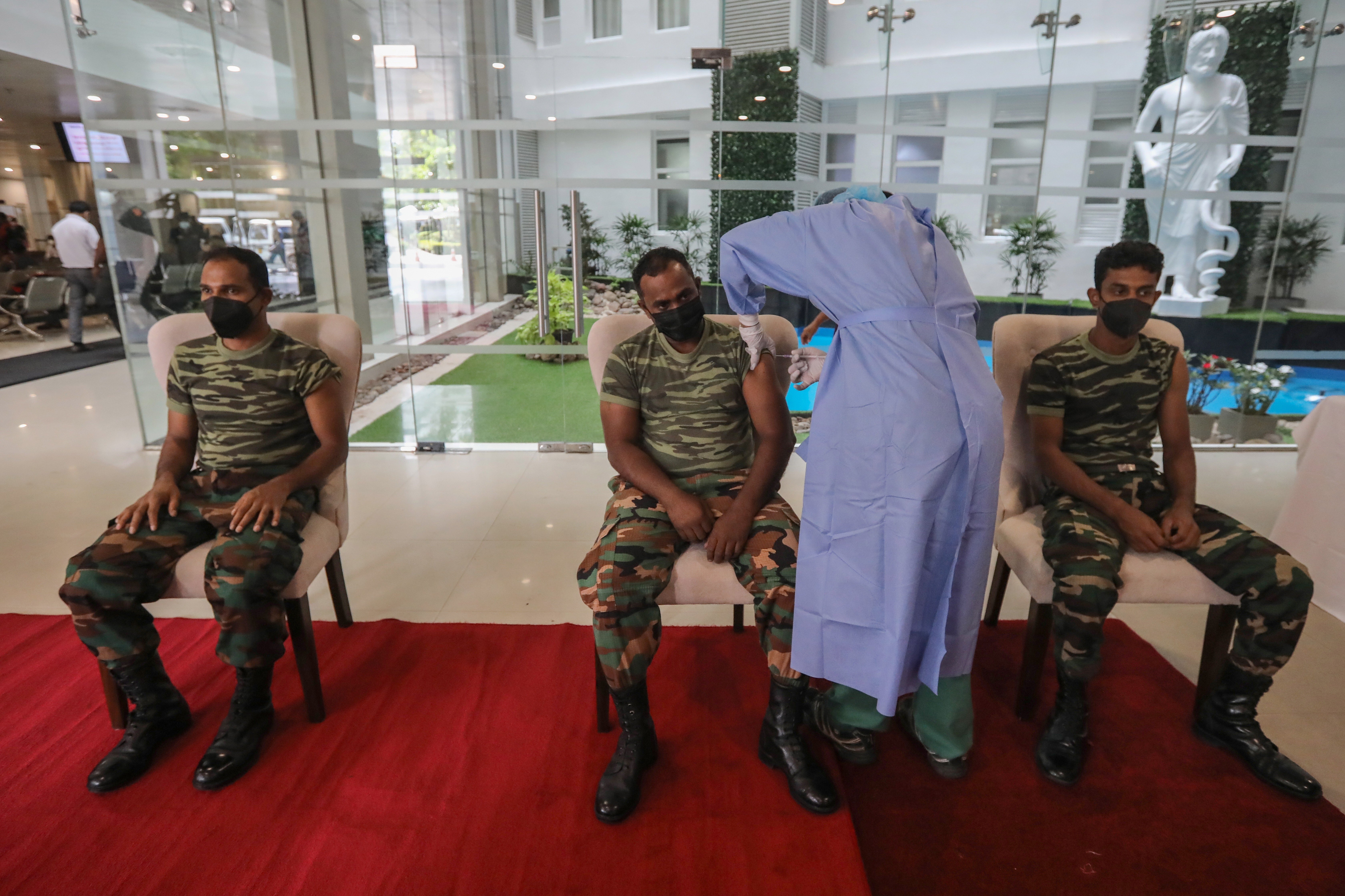 Sri Lankan soldiers receive their booster dose against Covid-19 at a military hospital in Colombo. The nation’s economy shrank a record 3.6 per cent in 2020 because of the pandemic. Now the government has announced a tax on car accidents to help claw some money back. Photo: EPA-EFE