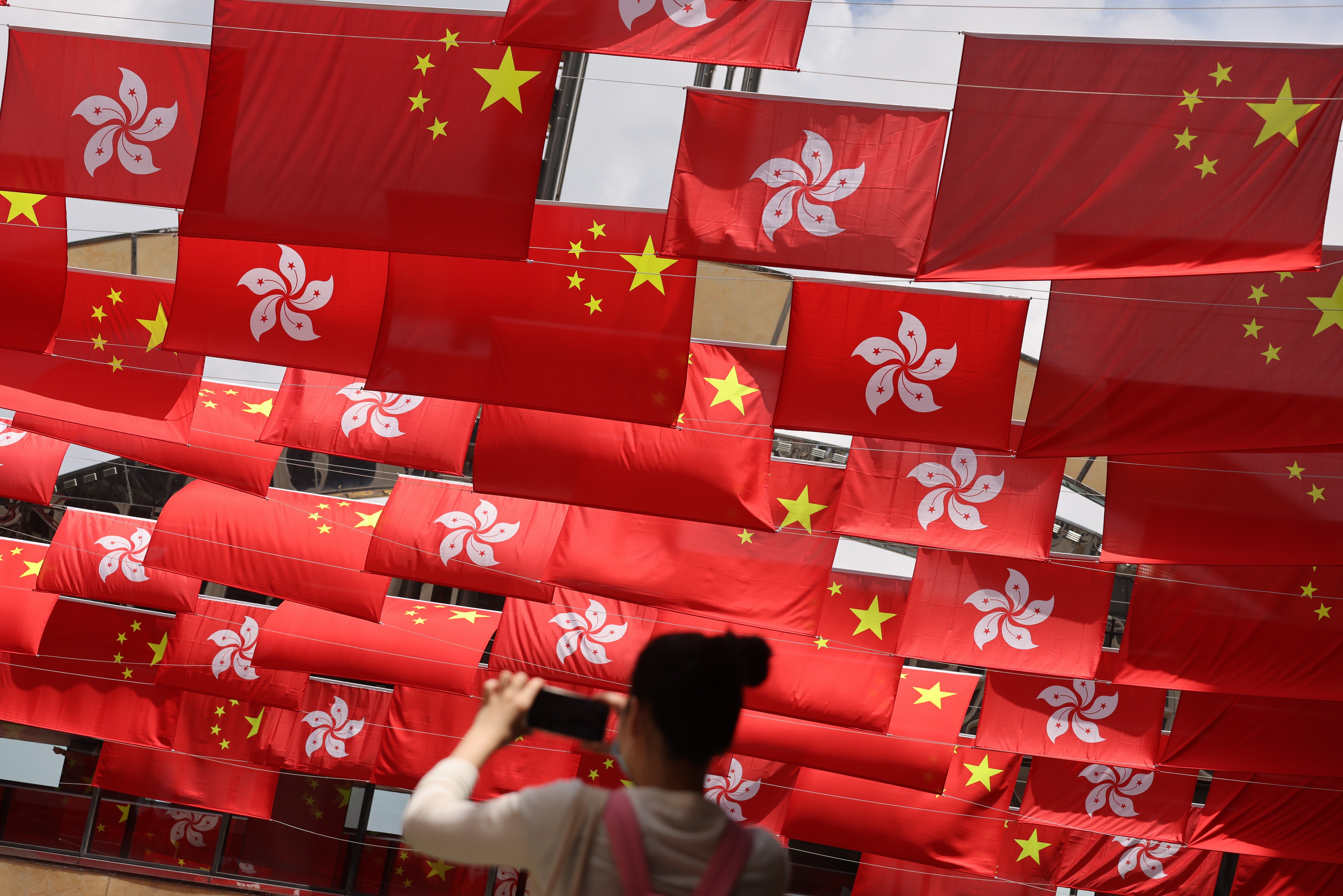 National and city flags in Hong Kong’s Tsim Sha Tsui marking the 24th anniversary of the handover. Photo: May Tse