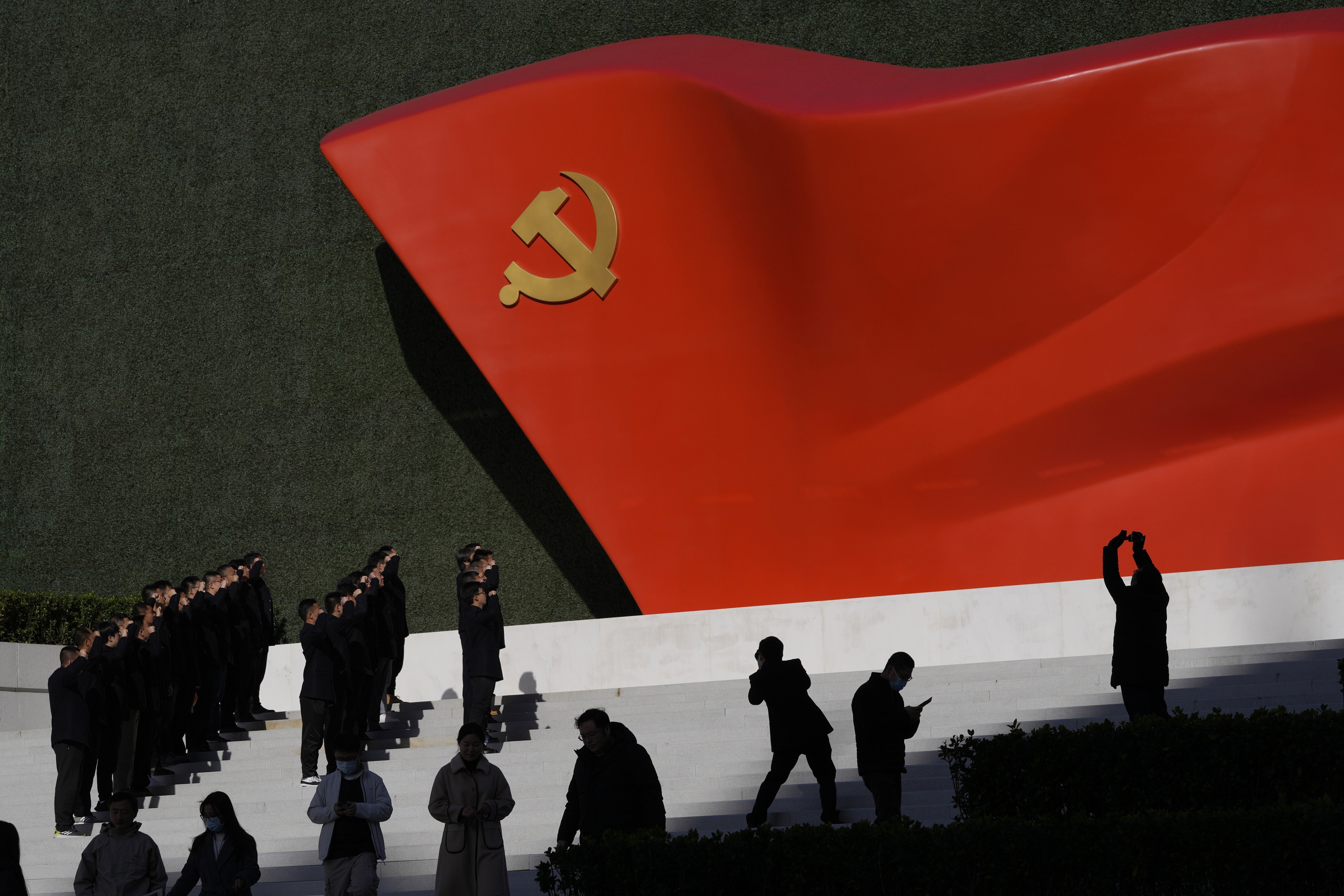 Party members pose for photos with a sculpture of the party flag outside the Museum of the Communist Party of China in Beijing. A resolution adopted at the sixth plenum of the Central Committee dedicated a section to “safeguarding national security”. Photo: AP