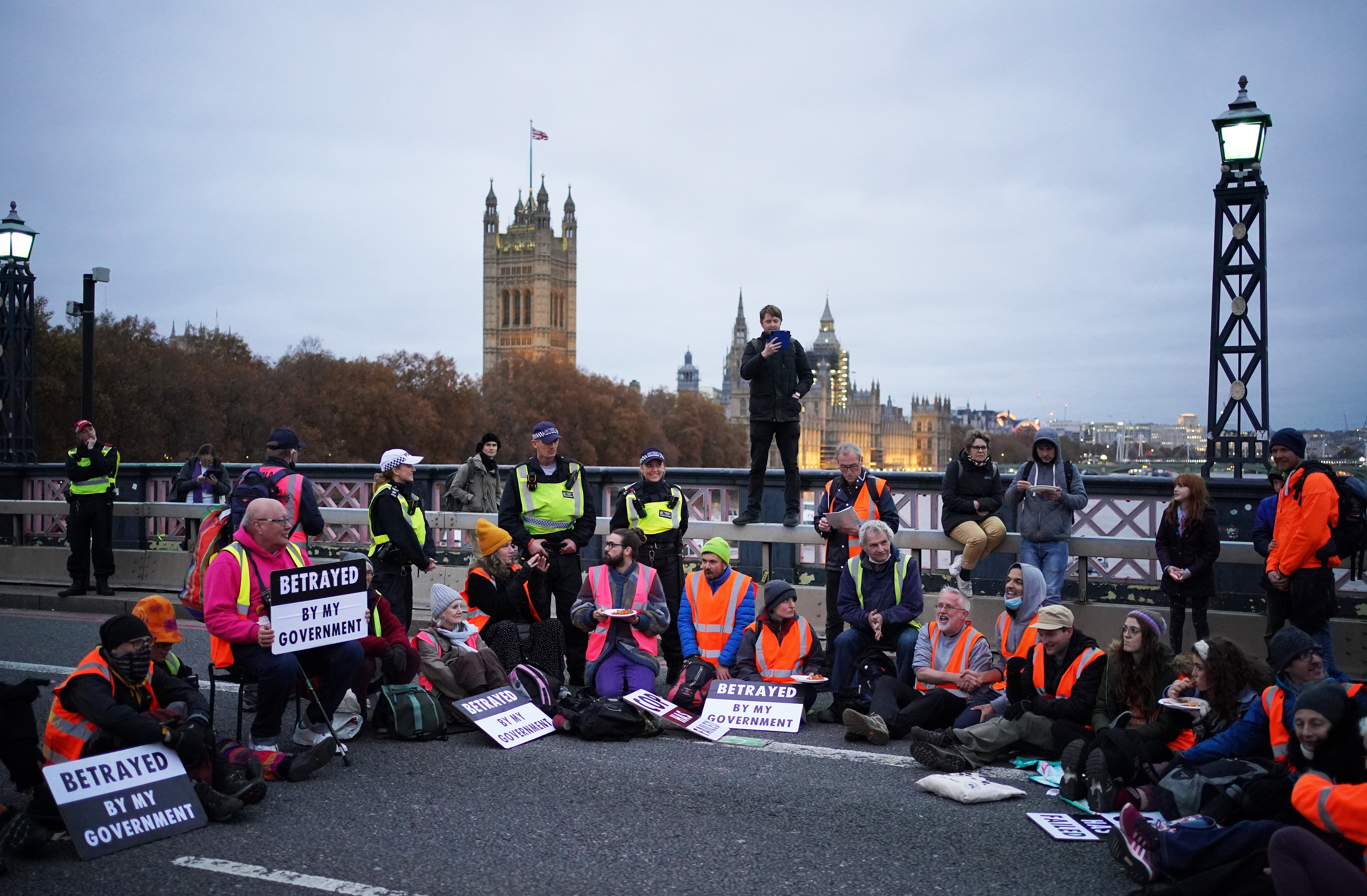 Supporters of the nine jailed Insulate Britain climate activists take part in a demonstration on Lambeth Bridge in London. Photo: PA Wire / DPA