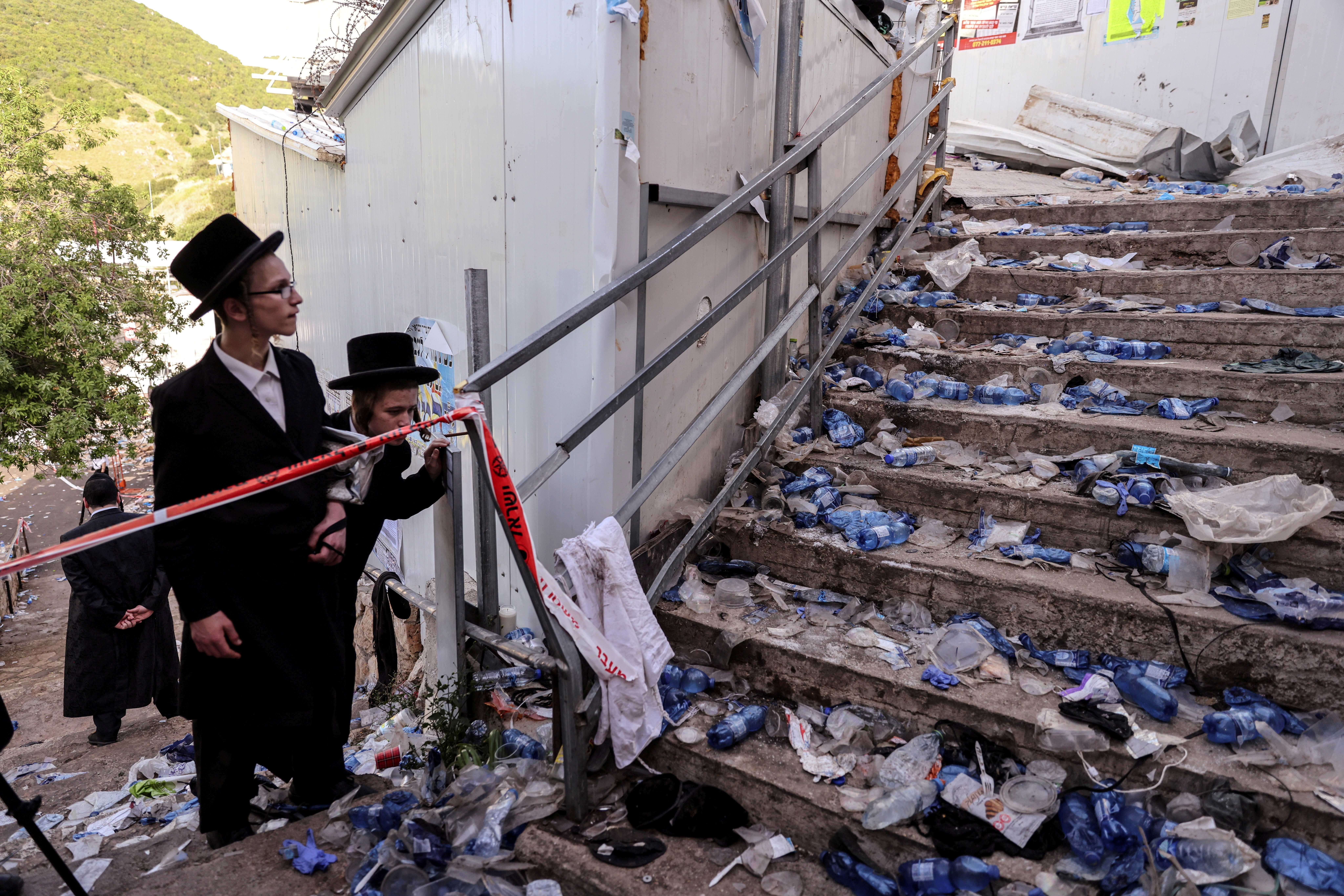 Ultra Orthodox Jews look at stairs with waste on them in Meron, Israel where 45 deaths were reported in April 2021 among thousands gathered at the tomb of a second-century sage for annual commemorations. Photo: Reuters