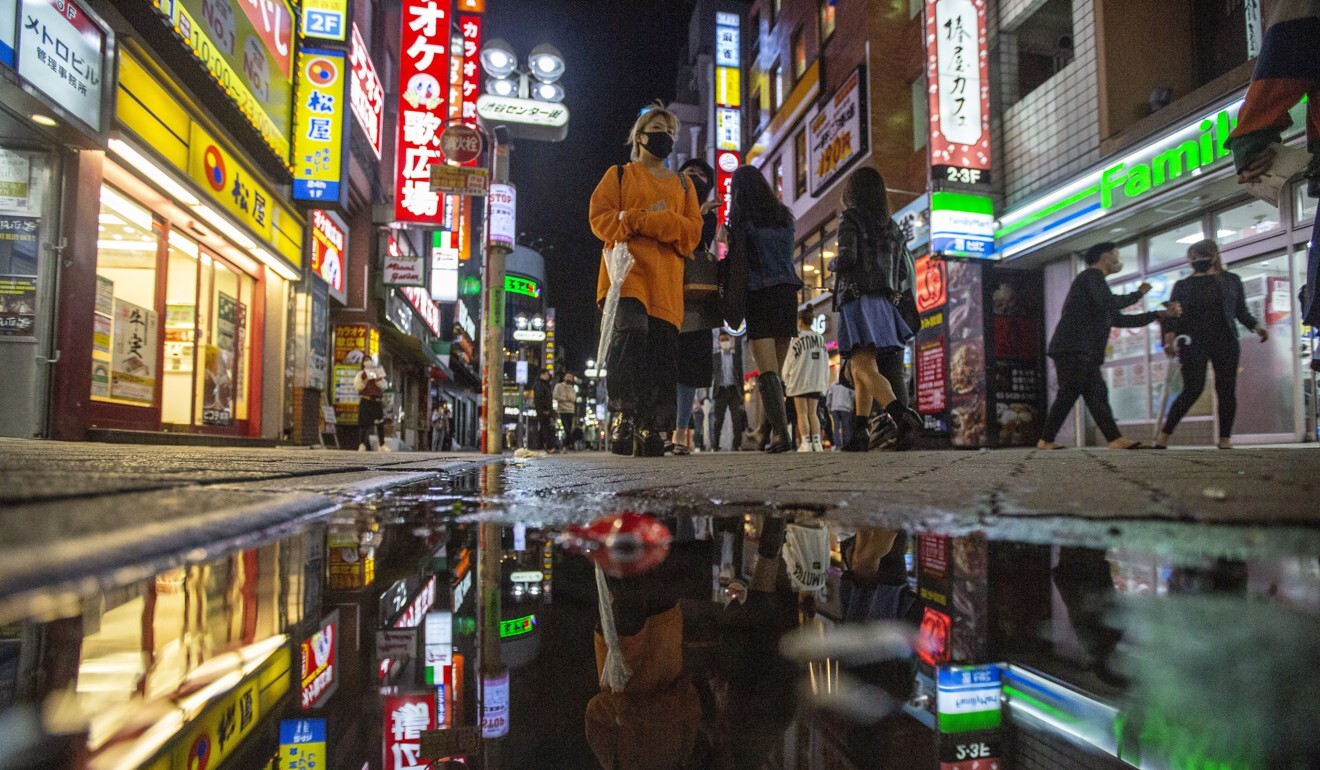 People walk along streets full of shops, bars and restaurants in Shibuya, an entertainment district of Tokyo. Photo: AP