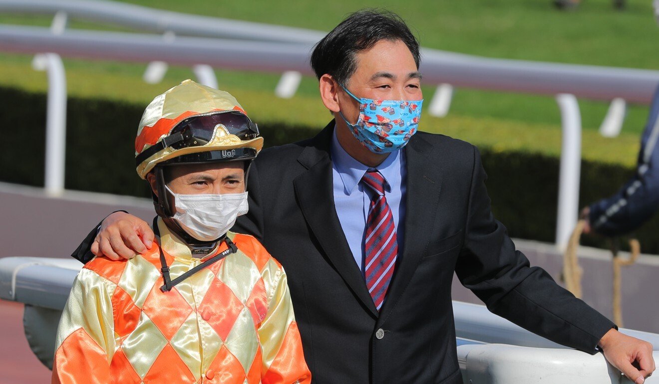 Jockey Matthew Poon and trainer Michael Chang celebrate Speed Force’s victory.