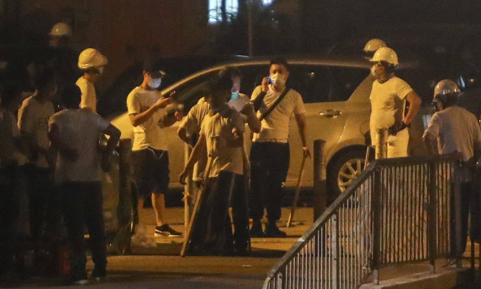 Men in white T-shirts attacked black-clad protesters and passengers.