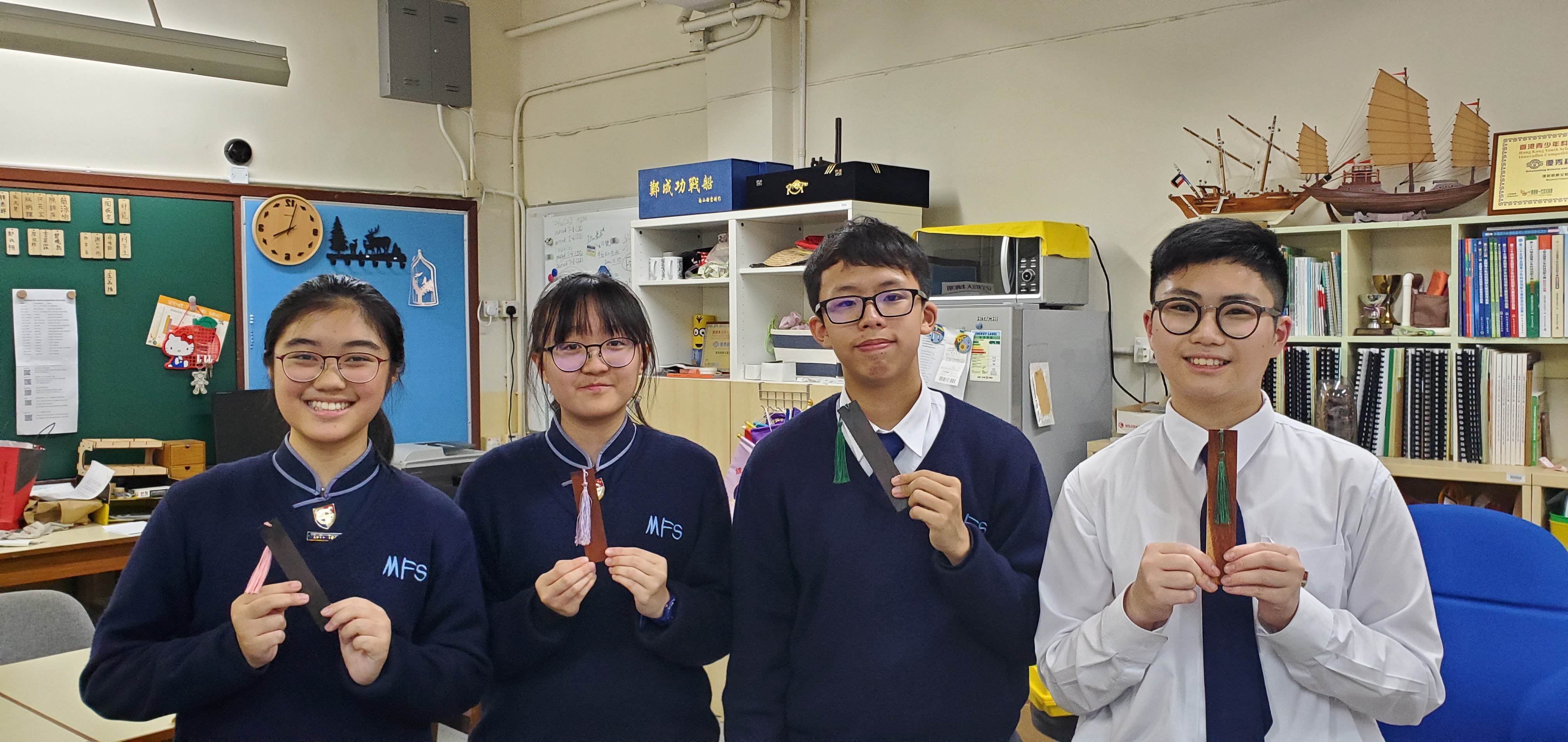 (From left) Angel Liu, Shirley Tse, Philip Siu, and Cliff Wong conduct a Stem workshop which helps students develop their maths and biology knowledge. 