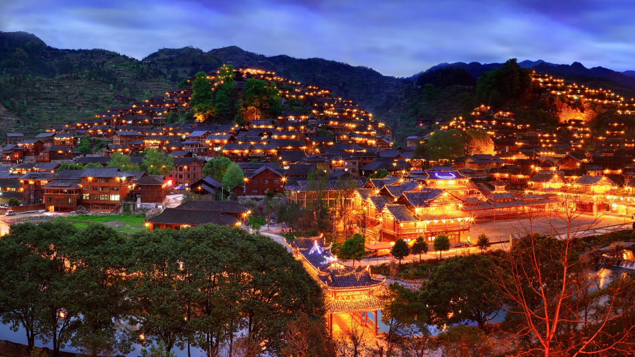 Xijiang’s villages, surrounded by mountains, offer a spectacular sight when they are lit up at night.