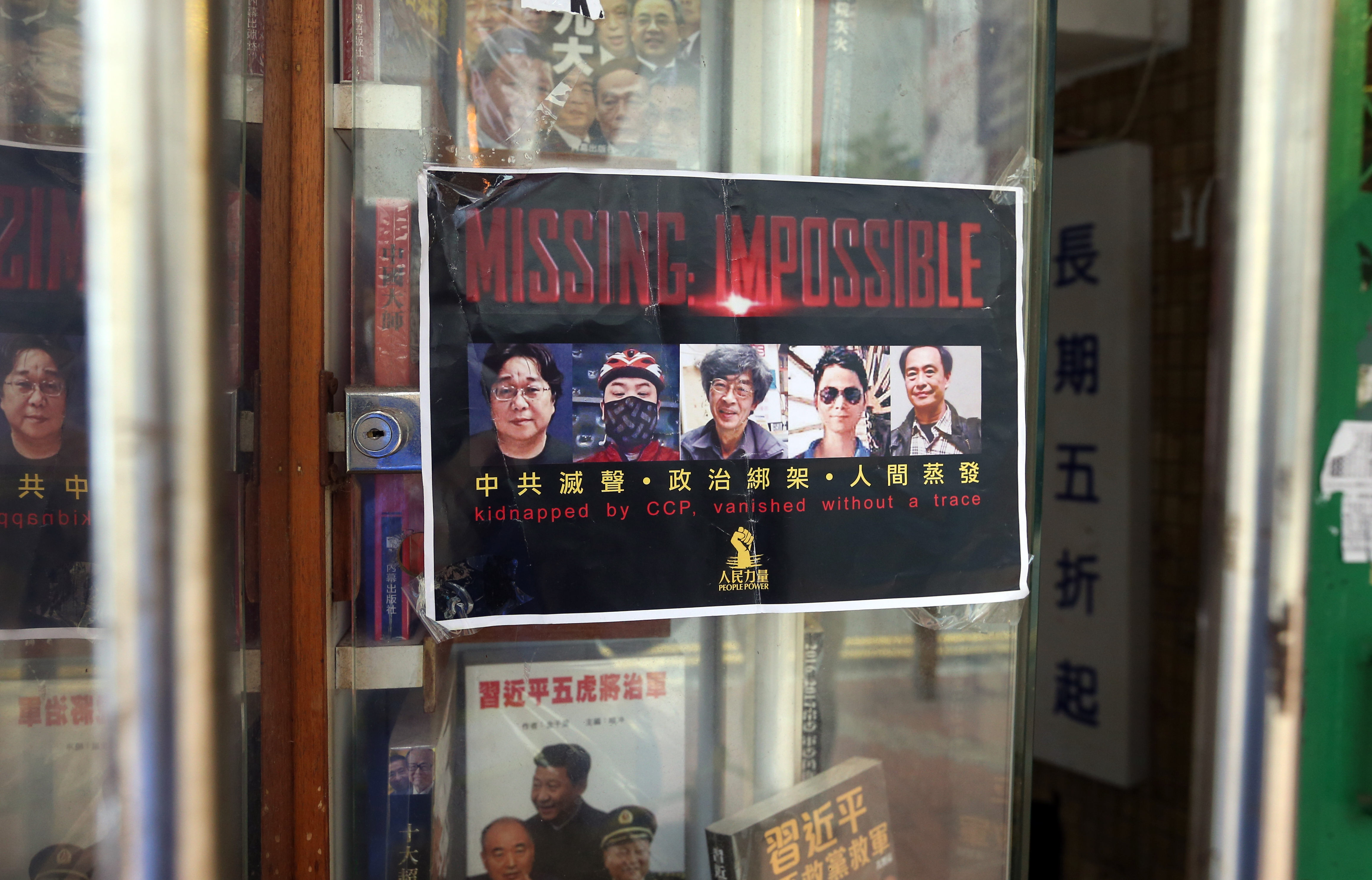 A poster showing the missing booksellers is seen outside the Causeway Bay Books, a bookstore located on Lockhart Road in Causeway Bay. Photo: K. Y. Cheng