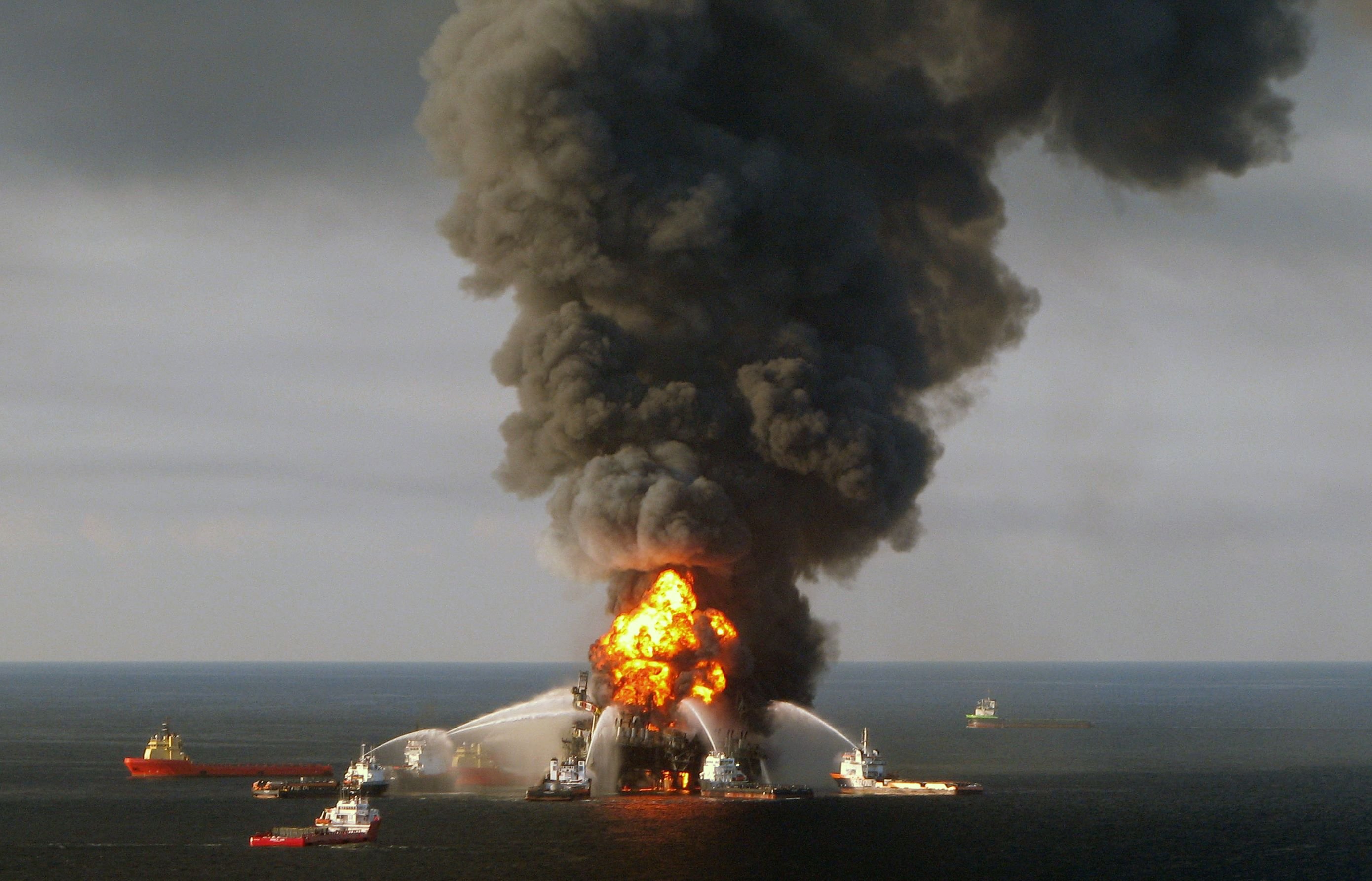(FILES) A file photo taken on on April 21, 2010 shows a US Coast Guard handout image of fire boat response crews as they battle the blazing remnants of the BP operated off shore oil rig, Deepwater Horizon, in the Gulf of Mexico. British energy giant BP will pay a record $20.8 billion to settle government claims for damages stemming from the deadly 2010 Gulf of Mexico oil spill, US Attorney General Loretta Lynch said October 5, 2015."This historic resolution is a strong and fitting response to the worst environmental disaster in American history," Lynch said at a press conference. "BP is receiving the punishment it deserves, while also providing critical compensation for the injuries it caused to the environment and the economy of the Gulf region." AFP PHOTO/US COAST GUARD/RESTRICTED TO EDITORIAL USE