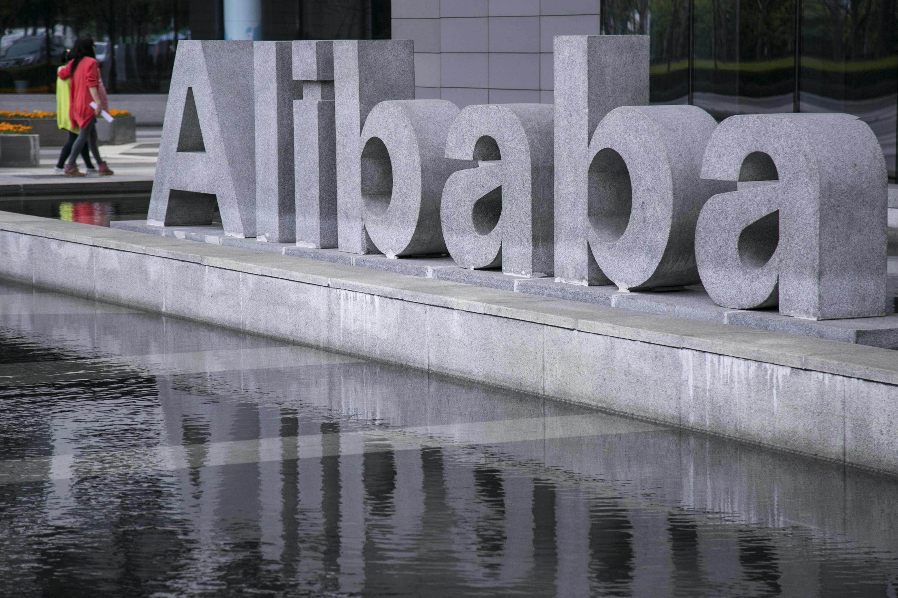 People walk at the headquarters of Alibaba in Hangzhou, Zhejiang province, in this April 23, 2014 file photo. Chinese e-commerce company Alibaba Group Holding Ltd said its expects to price its initial public offering at between $60 and $66 per American Depository share, September 5, 2014. REUTERS/Chance Chan (CHINA - Tags: BUSINESS) CHINA OUT. NO COMMERCIAL OR EDITORIAL SALES IN CHINA