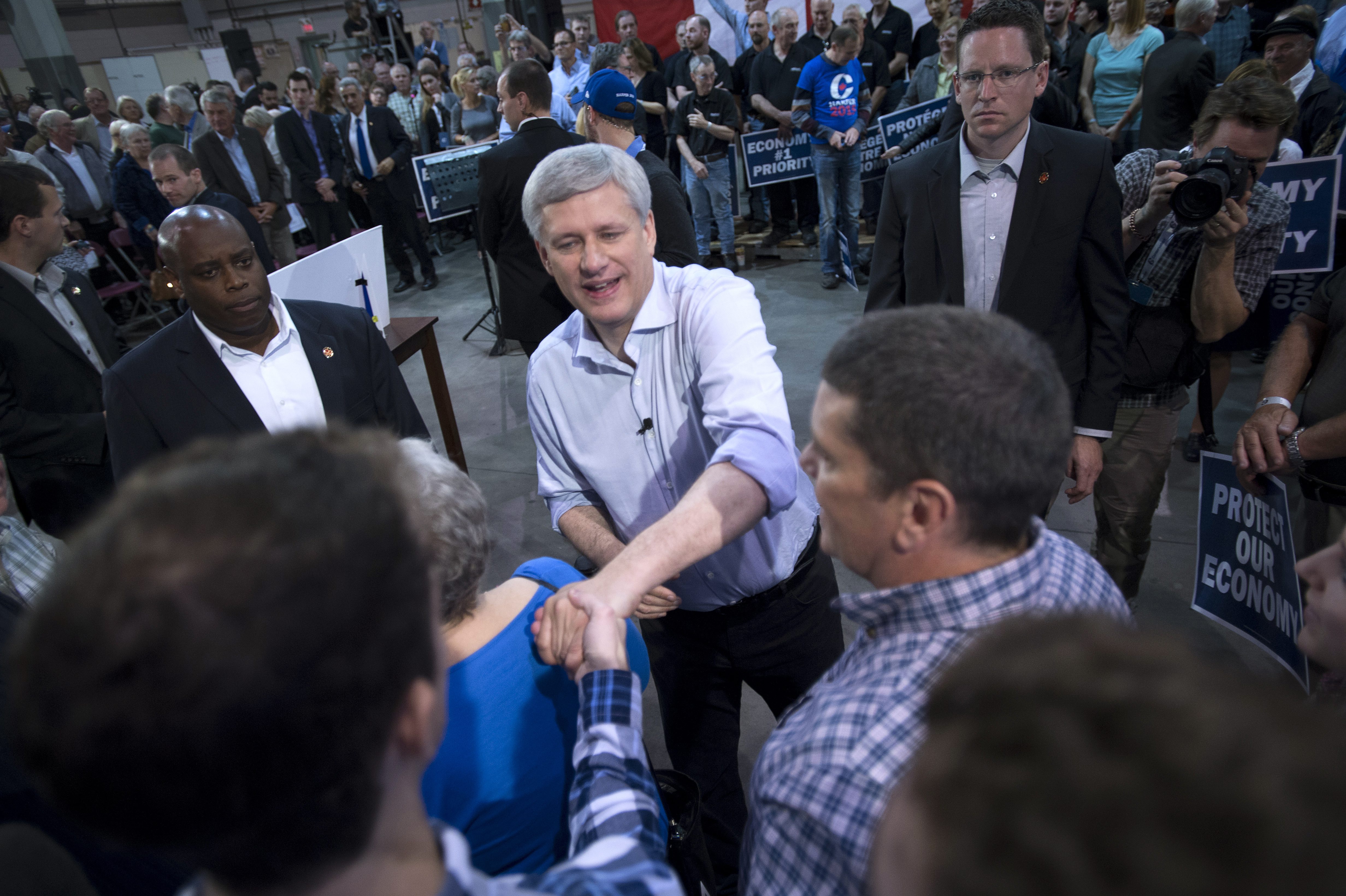 Conservative Leader Stephen Harper shakes hands with supporters during a campaign event at the J.P. Bowman tool and die company in Brantford, Ontario, Canada Wednesday, Oct. 14, 2015. (Jonathan Hayward/The Canadian Press via AP) MANDATORY CREDIT