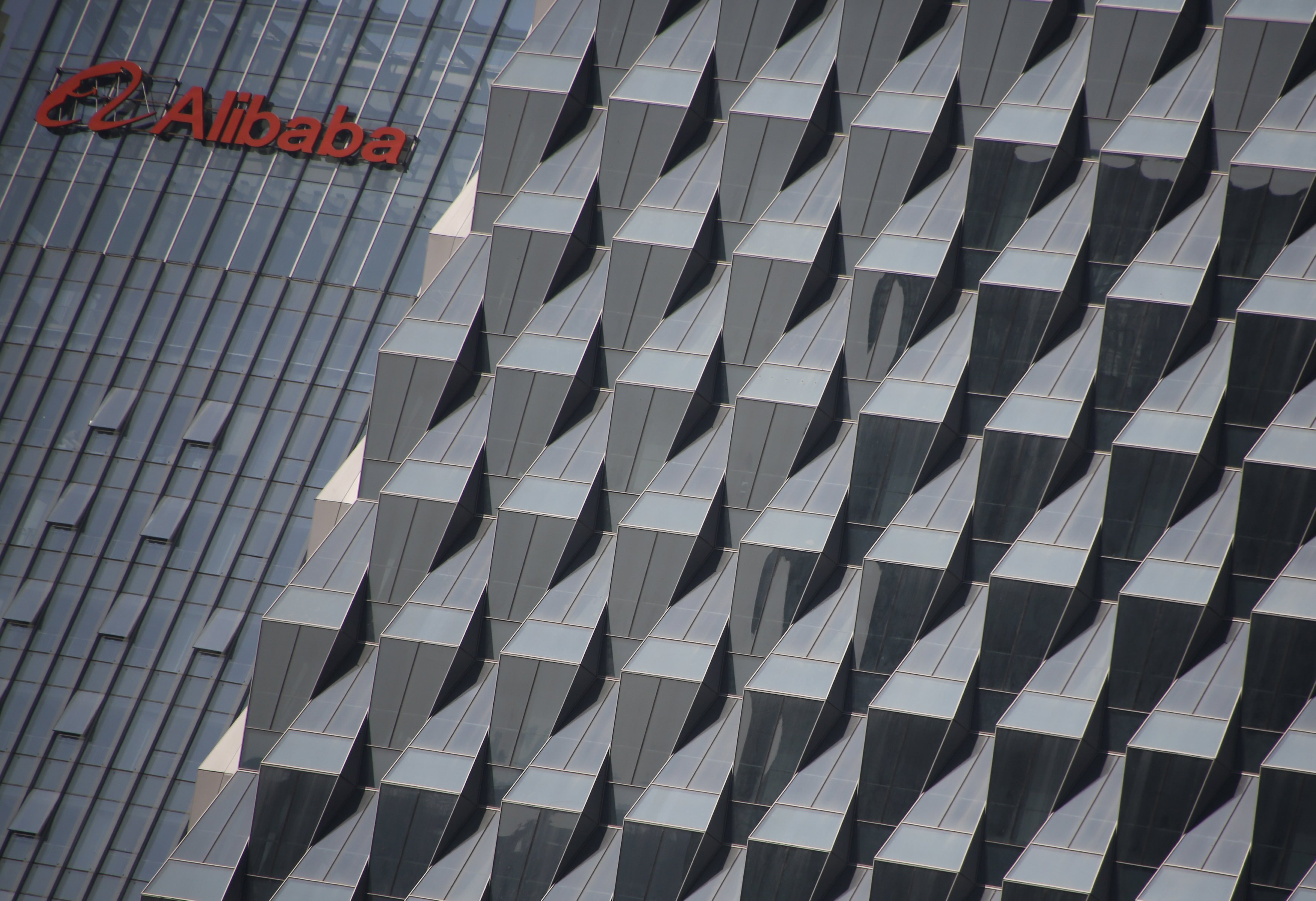 A logo of Alibaba Group is seen on a building under construction, where the company's Beijing headquarters will be, in Beijing, China, October 15, 2015. Chinese e-commerce giant Alibaba Group Holding Ltd is lobbying hard to stay off the U.S. Trade Representative's blacklist after coming under renewed pressure this year over suspected counterfeits sold on its shopping platforms. Picture taken October 15, 2015. REUTERS/Kim Kyung-Hoon