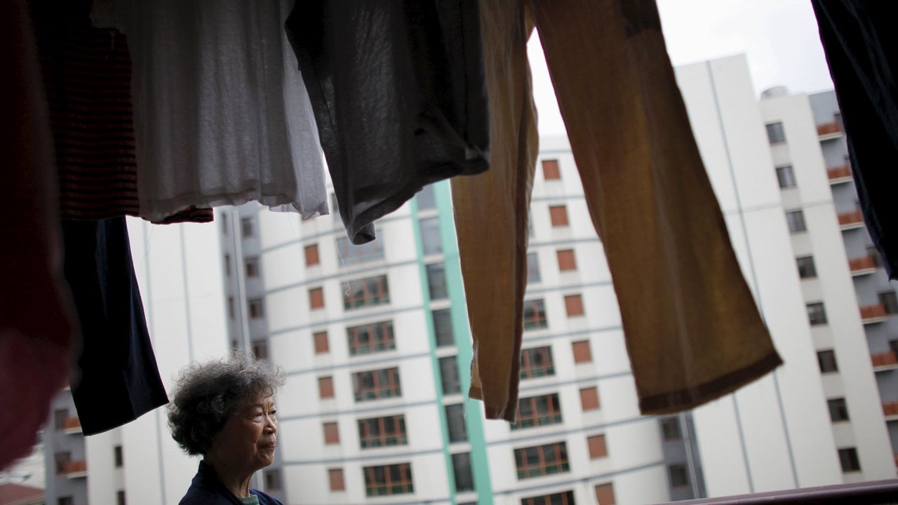 Zhu Yuefeng, 75, stands on the balcony of her apartment at the Cherish Yearn care center facility in Shanghai as China relaxed its restrictions on how many children families can have. Photo: Reuters