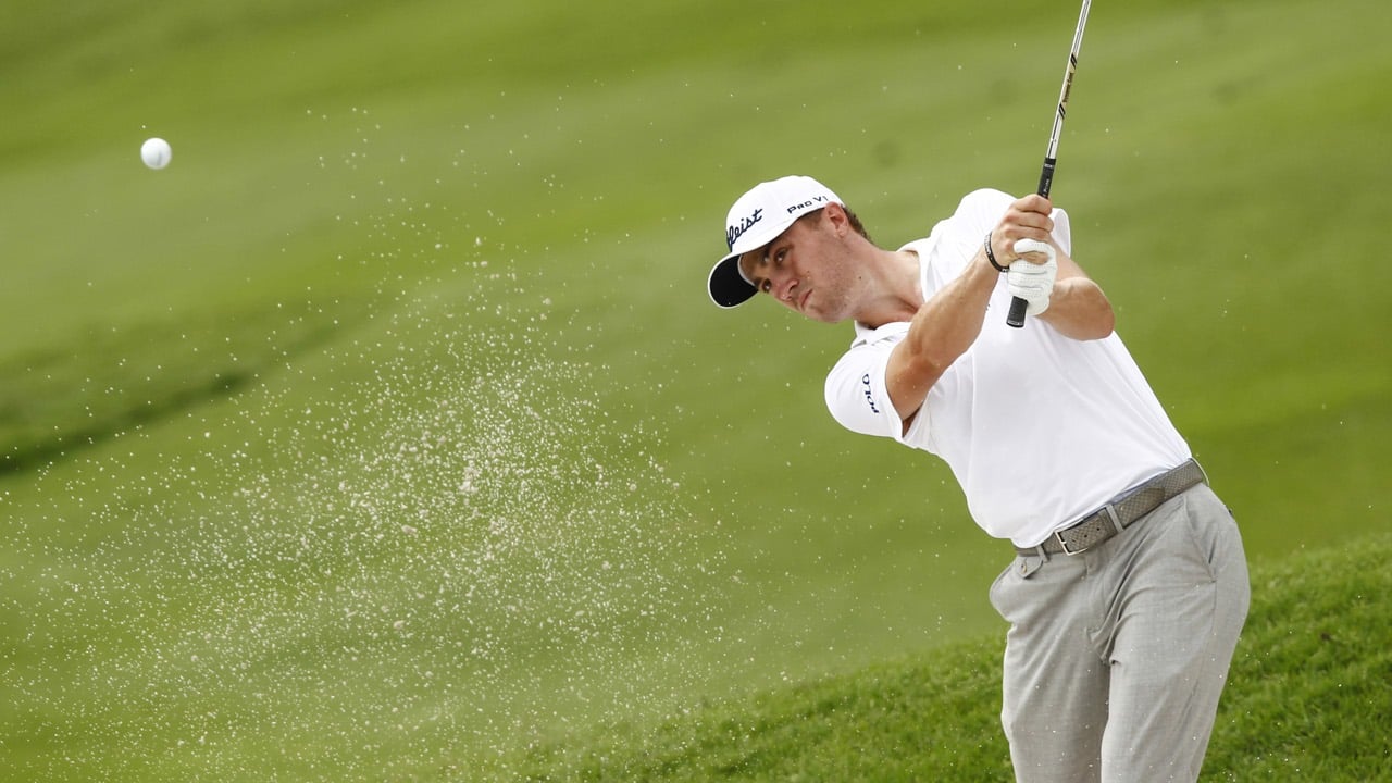 Justin Thomas of the US plays out of the bunker on the third hole during the final round of CIMB Classic. Photo: AP