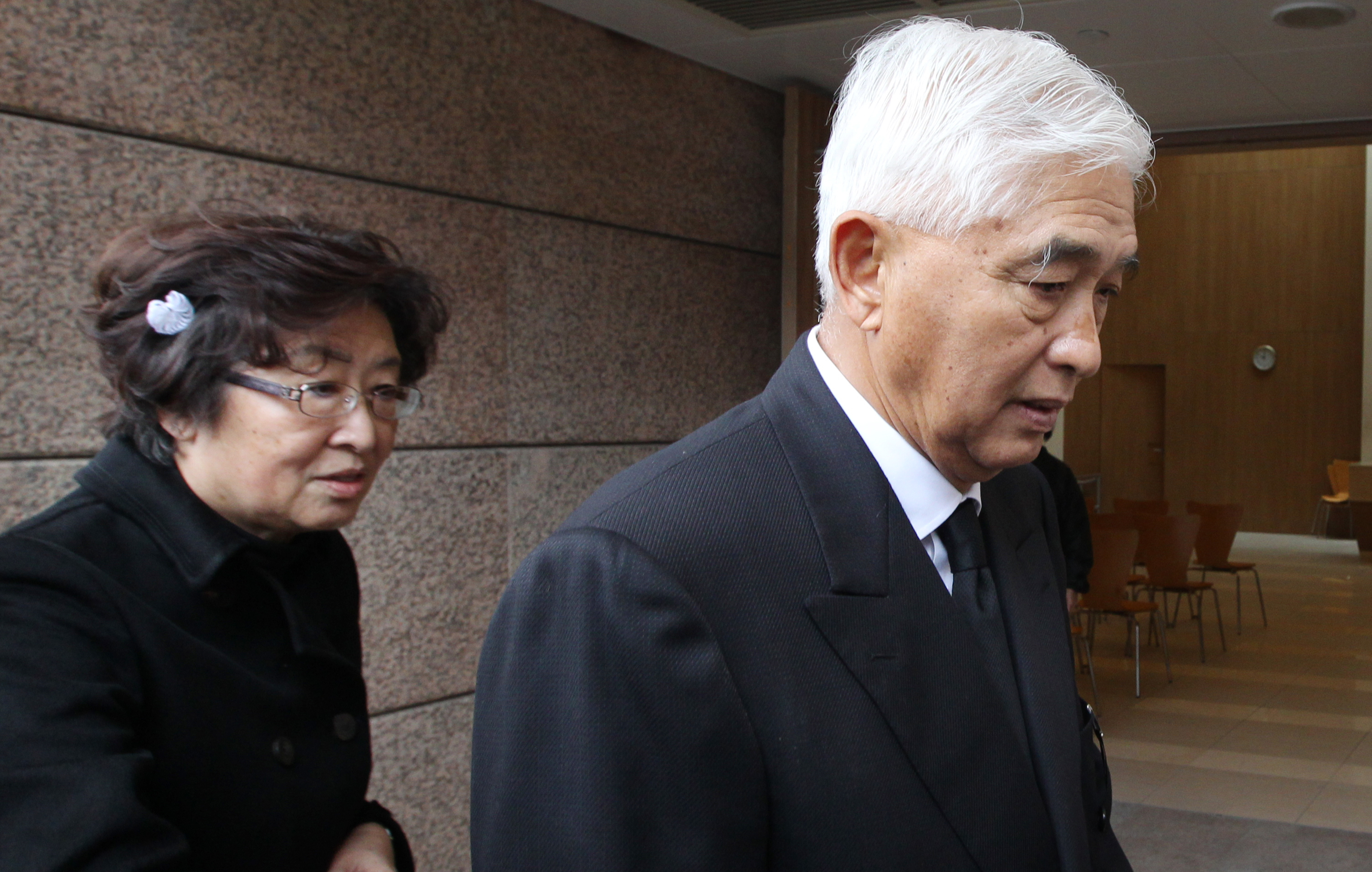 Larry Yung and his wife attend the funeral of his mother Yang Jian Qing at Cape Collinson. 13JAN14