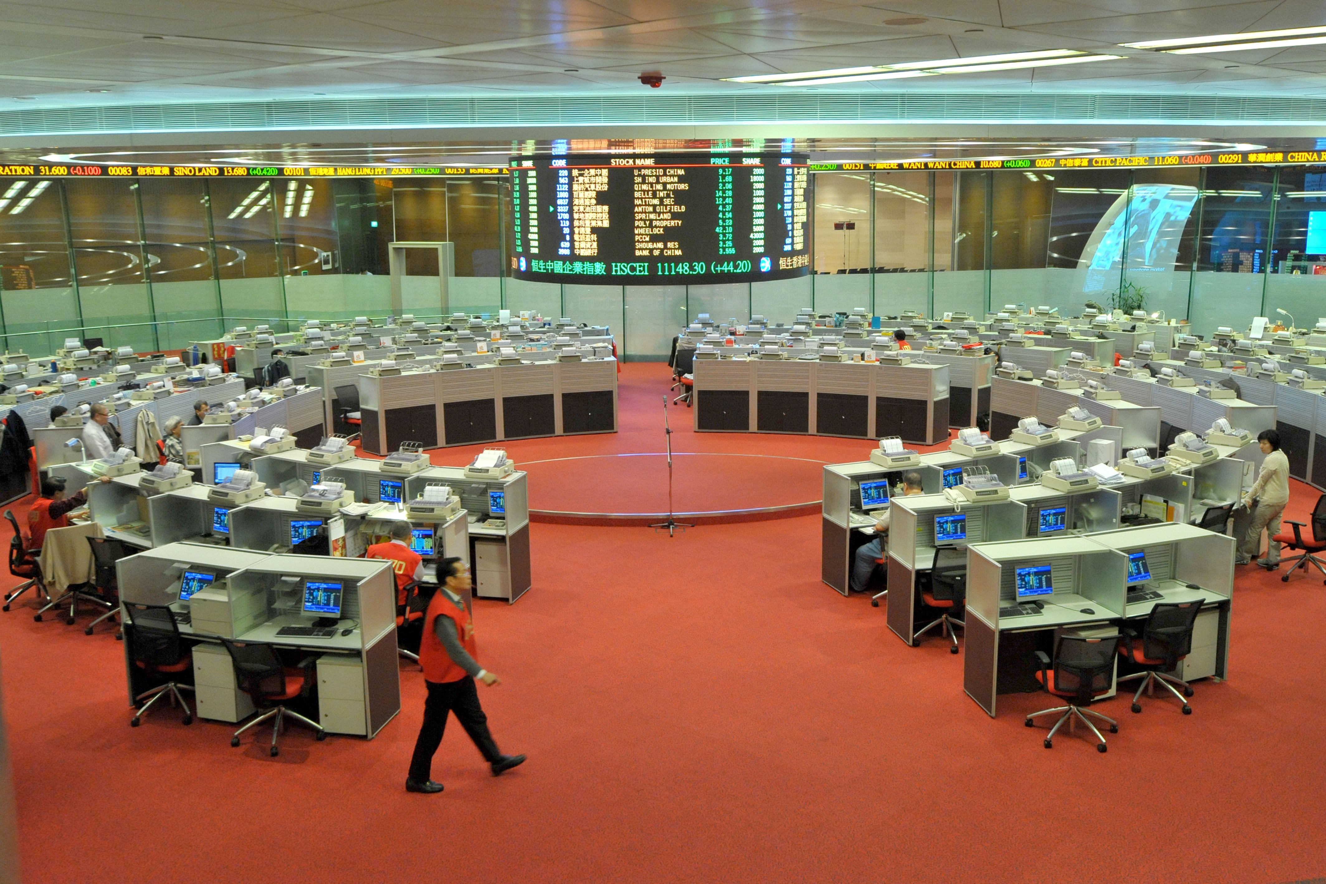 Floor traders take a break at the Hong Kong Stock Exchange while the Hang Seng index slumped in the morning session. 29SEP15