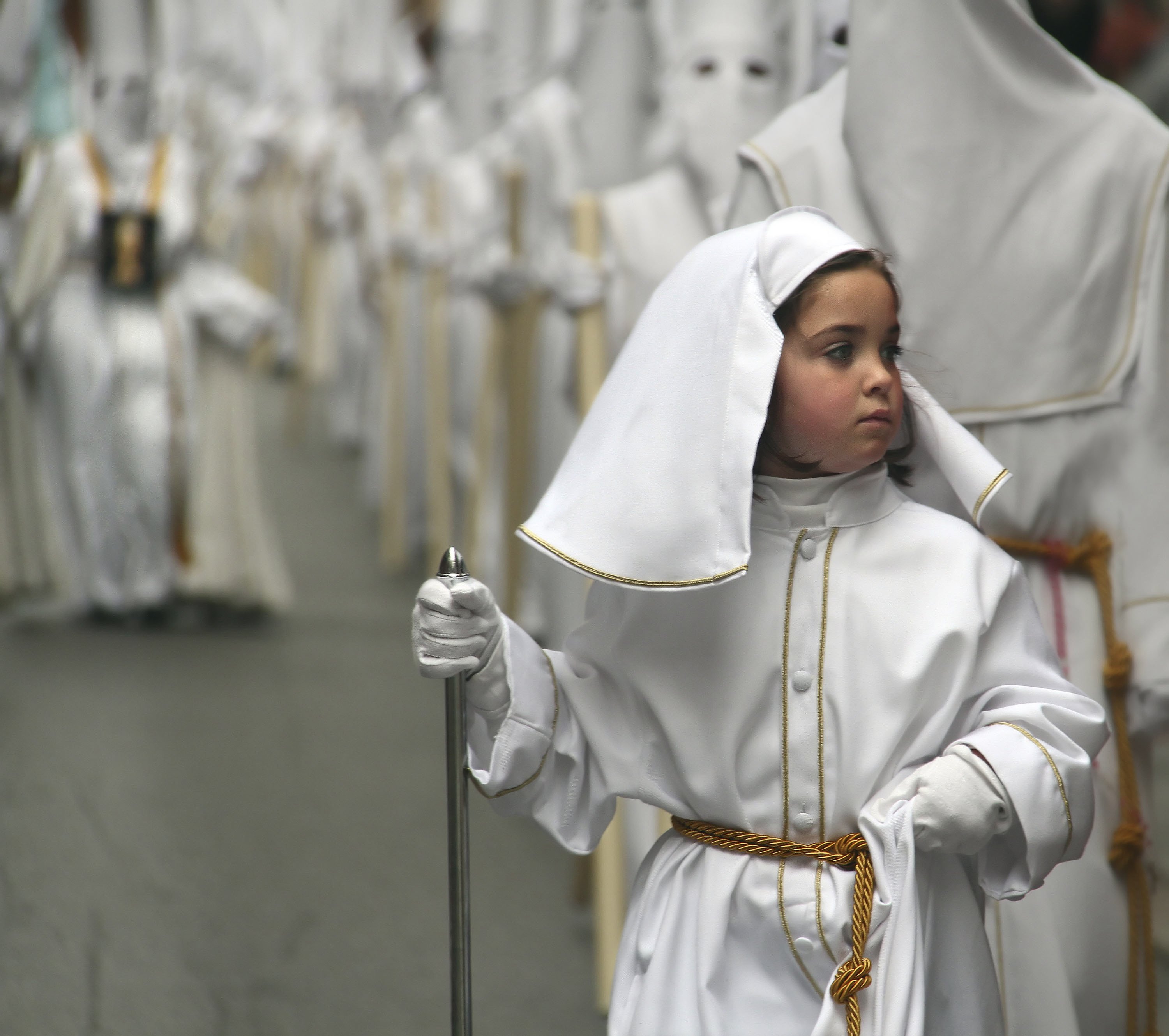 Malaga, Spain. 3rd April 2012 -- Child takes part in the ceremonial Holy Week procession. -- Every year in Malaga, southern Spain, different brotherhood groups or 'agrupaciones' lead a procession to celebrate Easter or Holy Week while wearing their distinctive outfits or 'capirotes'. [24NOVEMBER2015 FEATURE]