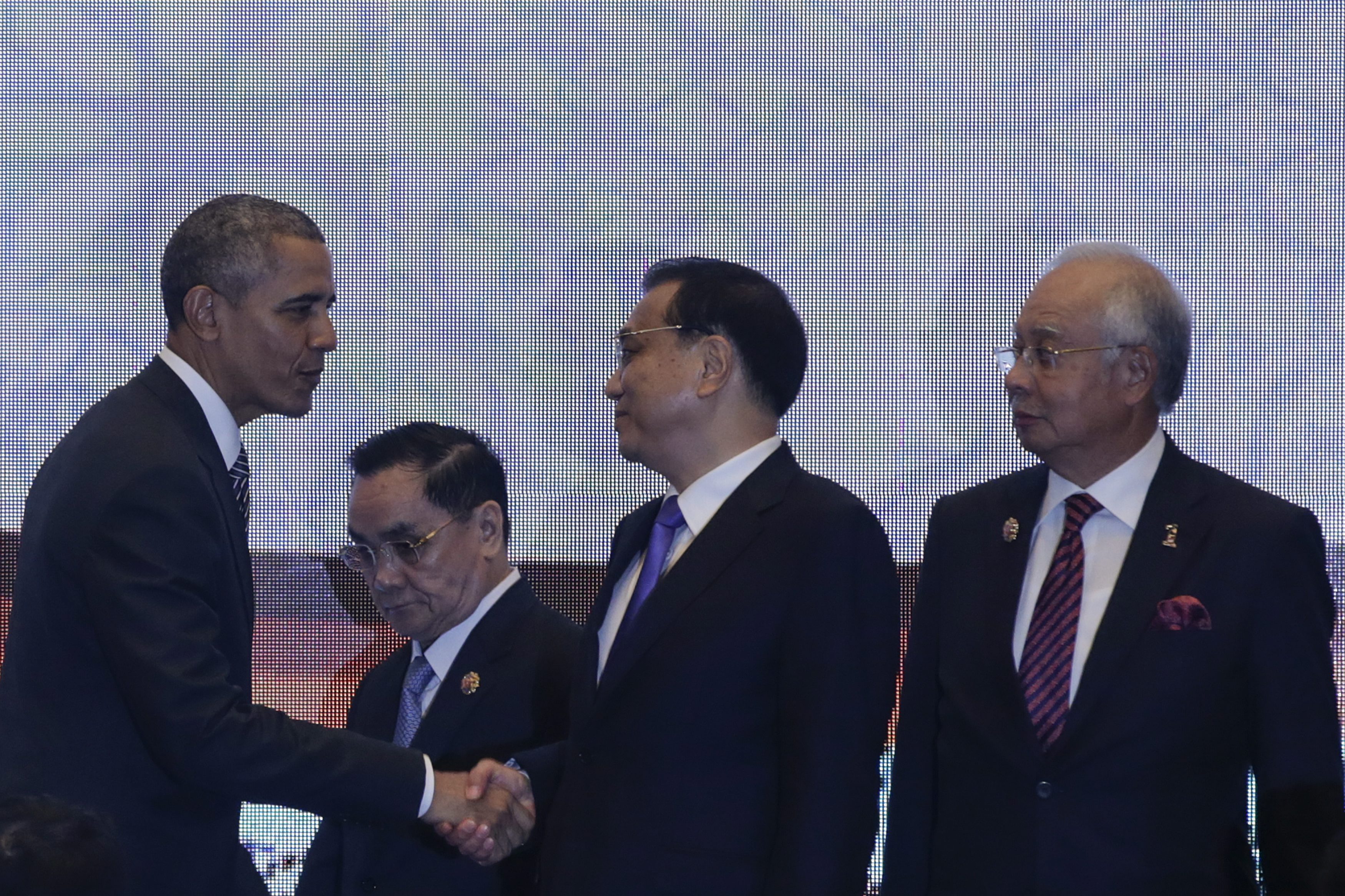 epa05036700 US President Barack Obama (L) shakes hands with Chinese Prime Minister Li Keqiang (2-R), as Malaysia Prime Minister Najib Razak (R) looks on, before posing for photograph at the 10th East Asia Summit during the 27th ASEAN summit in Kuala Lumpur, Malaysia, 22 November 2015. Malaysia is hosting the 27th ASEAN Summit, a meeting between ASEAN member countries and its three dialogue partners China, Japan and Korea, as well as a meeting of the East Asia Summit (EAS) forum. EPA/FAZRY ISMAIL