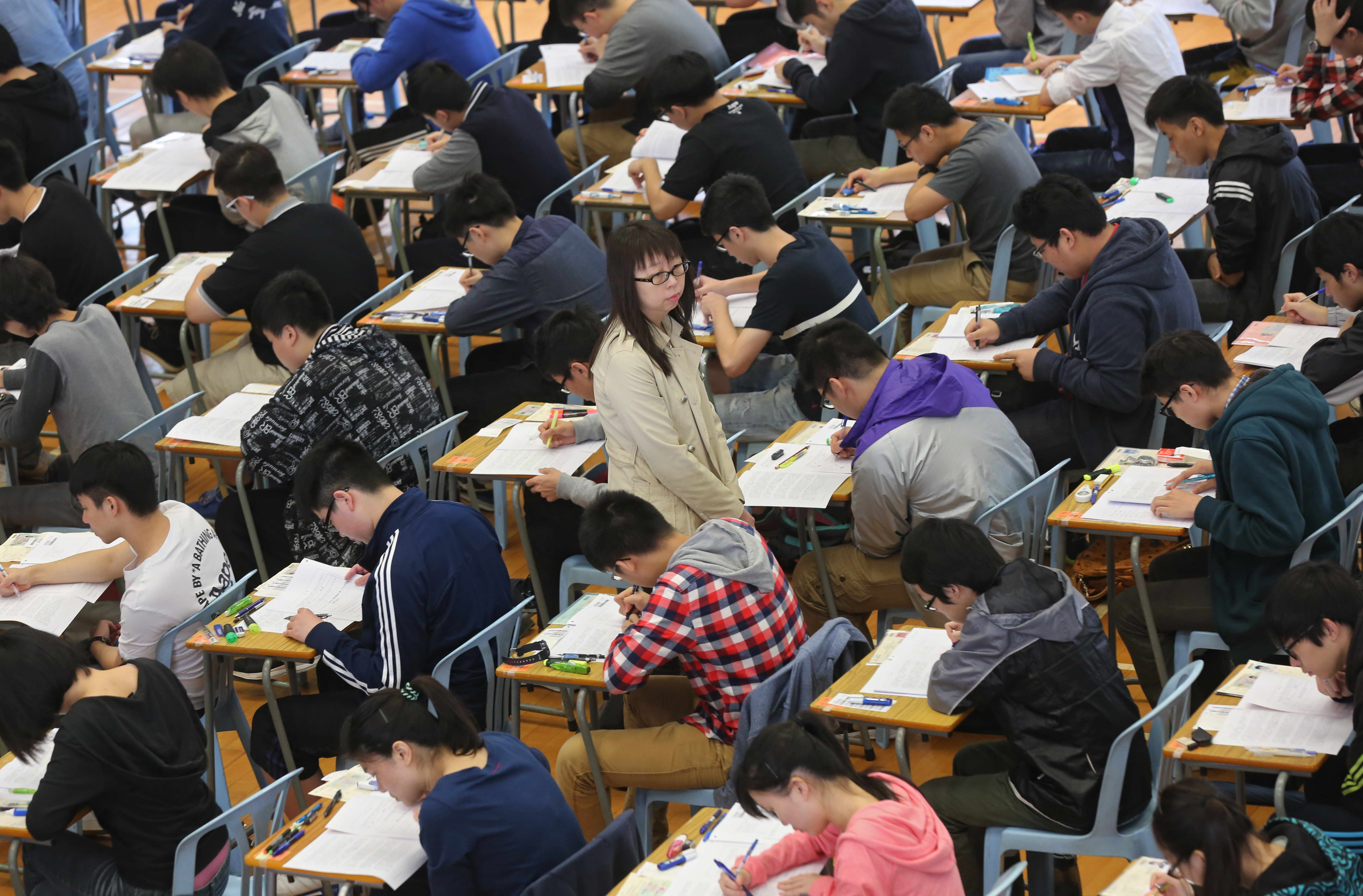 Students sit in for the Hong Kong Diploma of Secondary Education (HKDSE) Examination at the KowloonTechnical School Monday, March 30th, 2015, in Sham Shui Po. SCMP Pictures (POOL). 30MAR15