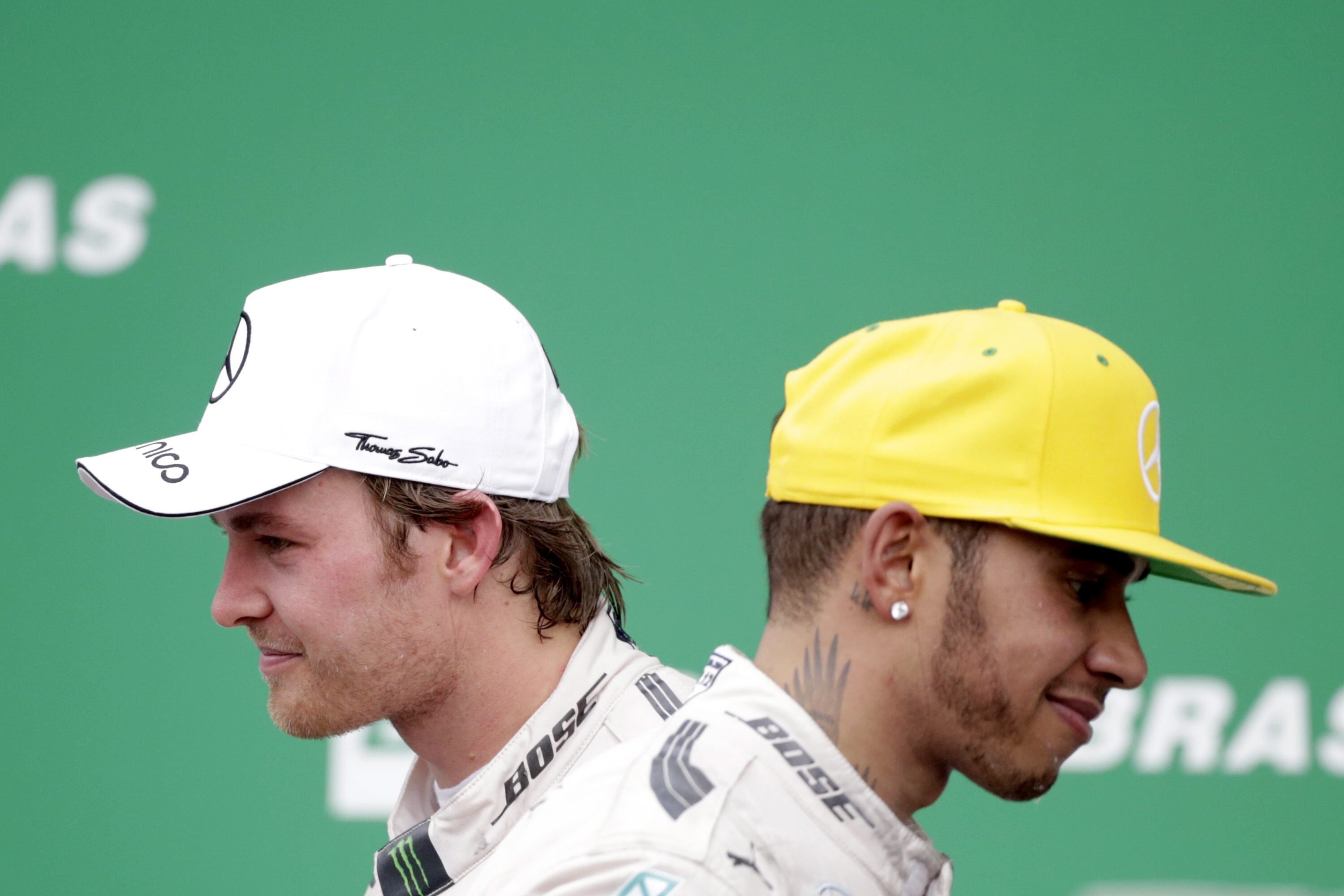epaselect epa05027214 First placed German Formula One driver Nico Rosberg (L) of Mercedes and his team mate, second placed British Lewis Hamilton (R) on the podium after the 2015 Formula Ona Grand Prix of Brazil at the Interlagos racing track, in Sao Paulo, Brazil, 15 November 2015. EPA/Fernando Bizerra Jr