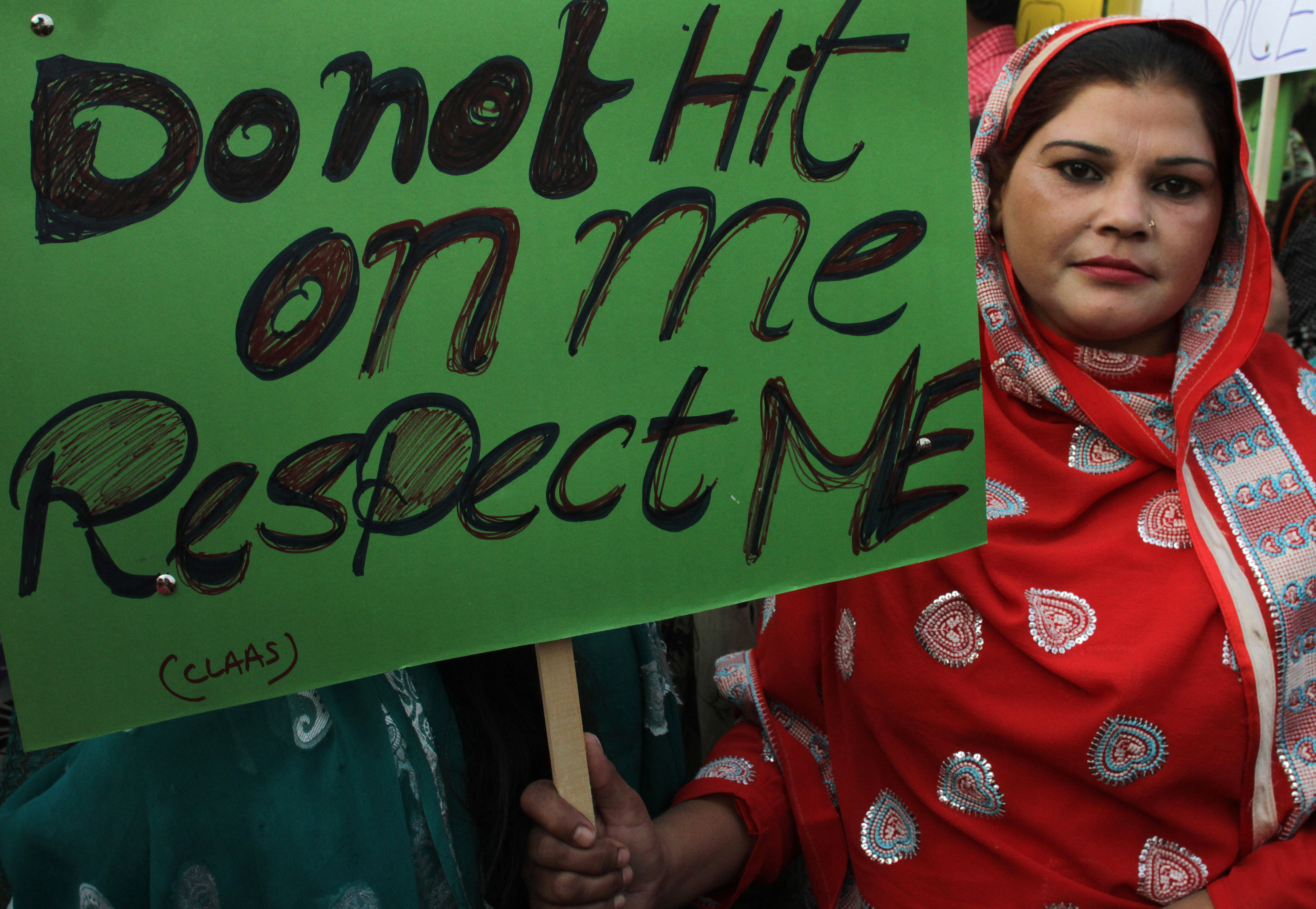 Pakistani woman holds a sign as she observes the International Day for the Elimination of Violence against Women, in Lahore, Pakistan, Wednesday, Nov. 25, 2015. (AP Photo/K.M. Chaudary)