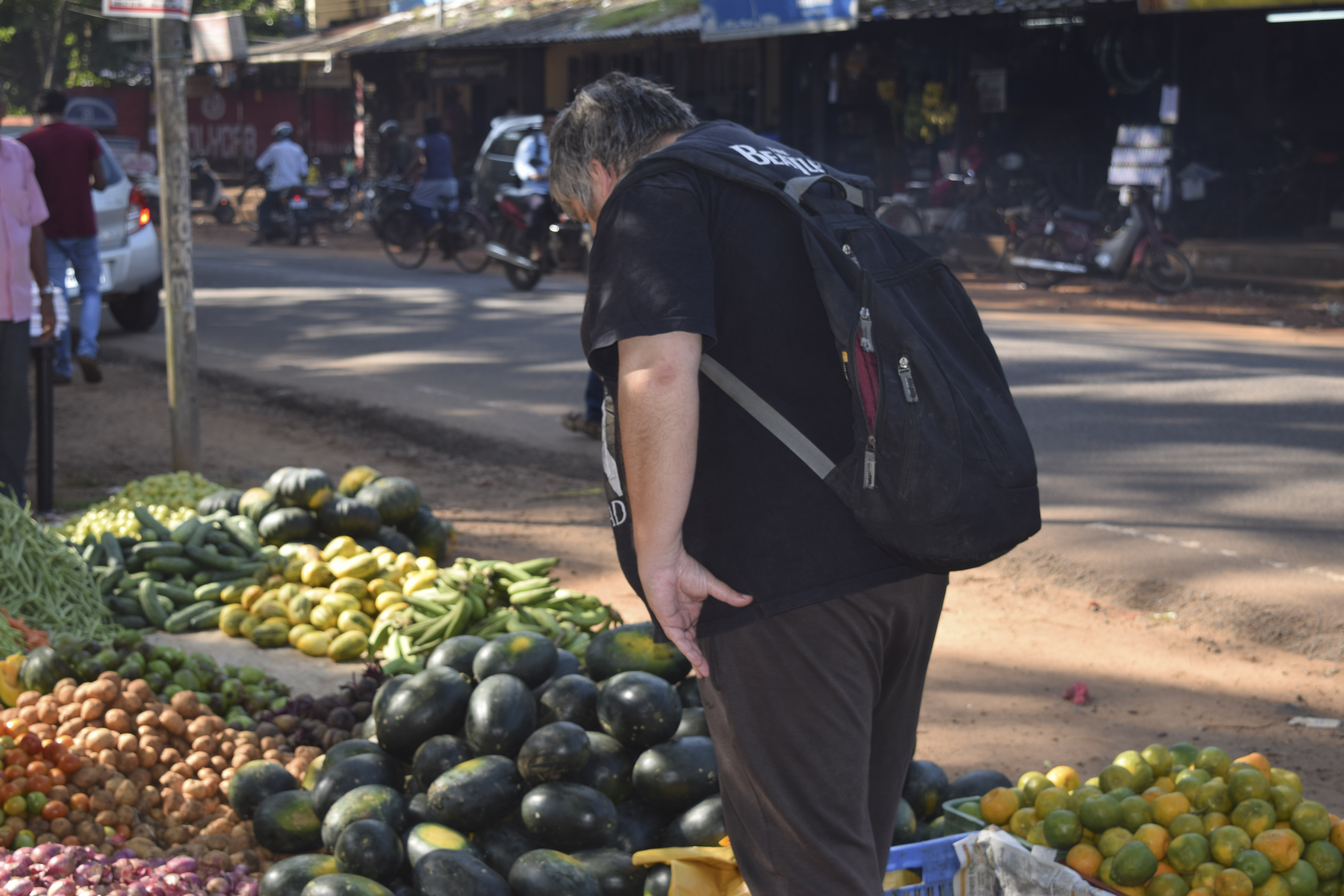 This image shows writer Mischa Moselle in front roadside fruit and vegetable market, in Calicut, India. 27NOV15 [01DECEMBER2015 FEATURE]