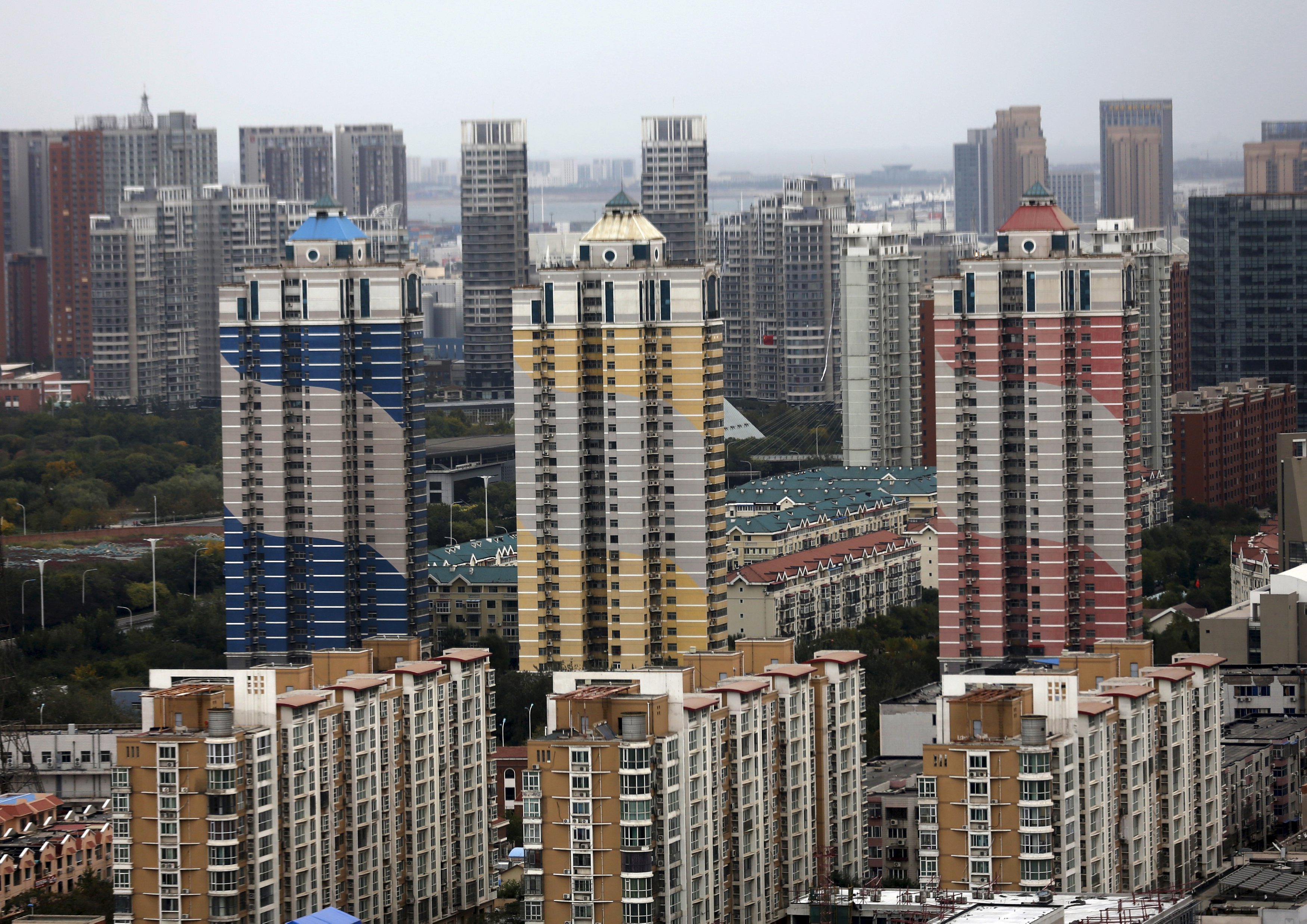 Residential buildings are seen at the Binhai new district in Tianjin, China, October 18, 2015. With prices of new homes rising by about 10 percent since August's chemical blast to meet an increase in demand, finding new homes outside the disaster area for most of those affected is a costly - and frustrating - process. Picture taken October 18, 2015. REUTERS/Kim Kyung-Hoon