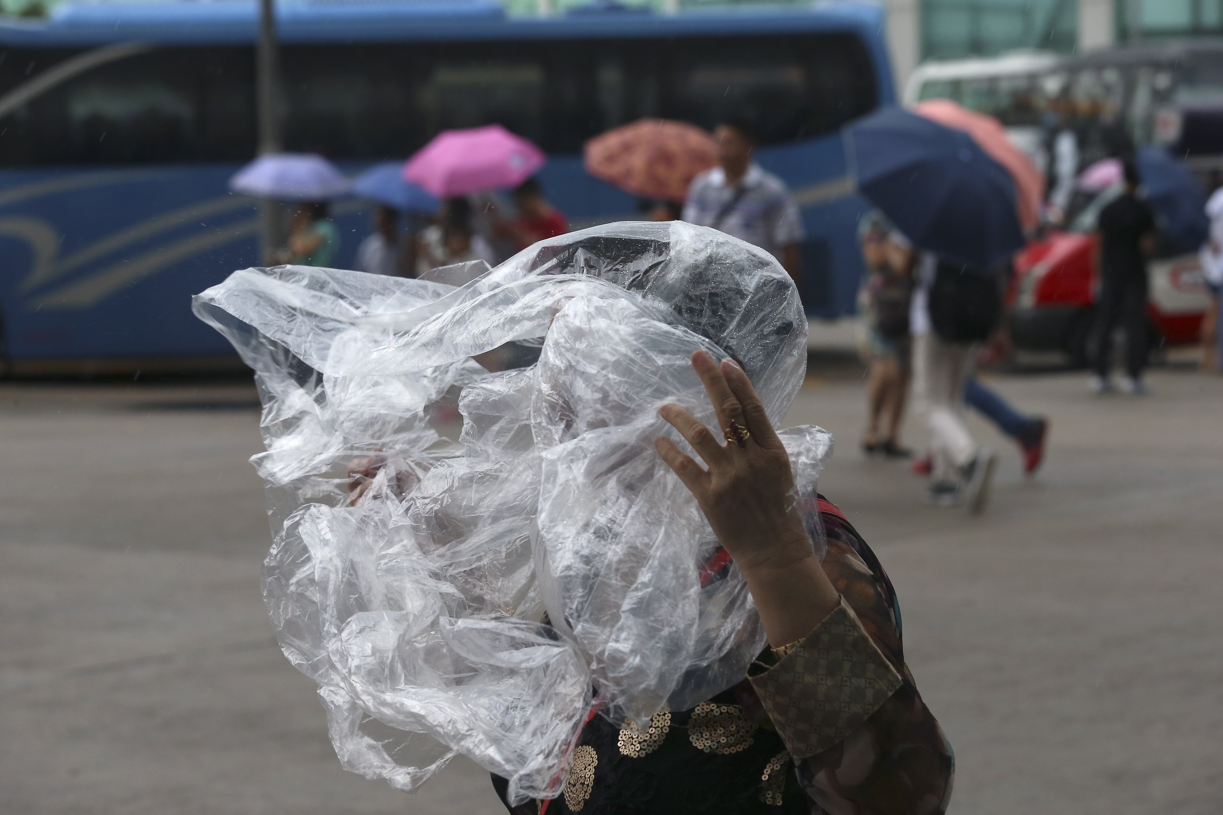 Tourists in Golden Bauhinia Square during Observatory has issued the Strong Wind Signal Number three as tropical storm Mujigae closer to Hong Kong. 04OCT15