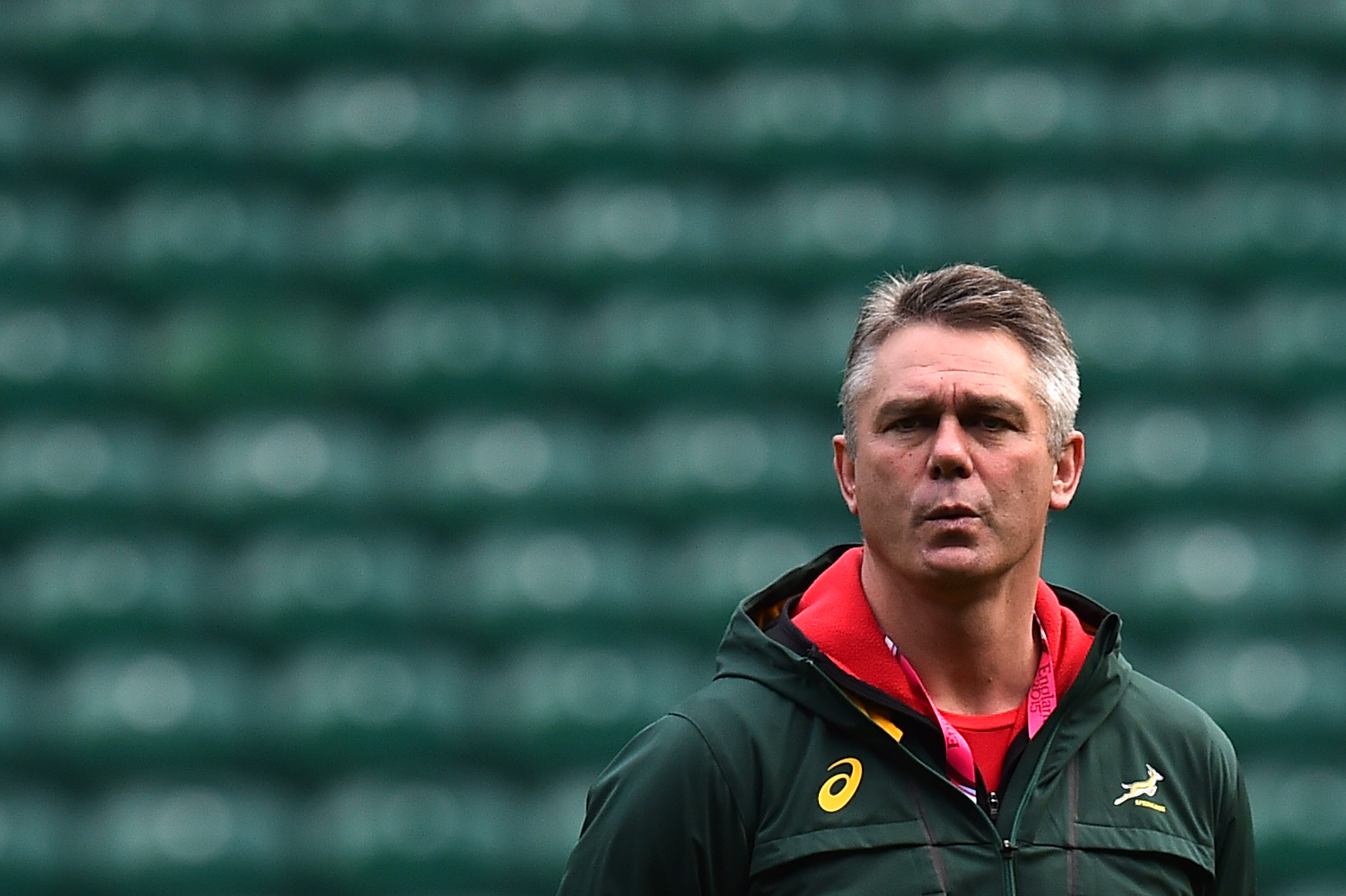 (FILES) This file photo taken on October 23, 2015 shows South Africa's head coach Heyneke Meyer watching his players during the captain's run at Twickenham Stadium, west of London, on the eve of the team's 2015 Rugby Union World Cup semi-final match against New Zealand. Meyer is to step down from his position, the South African Rugby Union (SARU) announced on Twitter December 3, 2015. / AFP / GABRIEL BOUYS