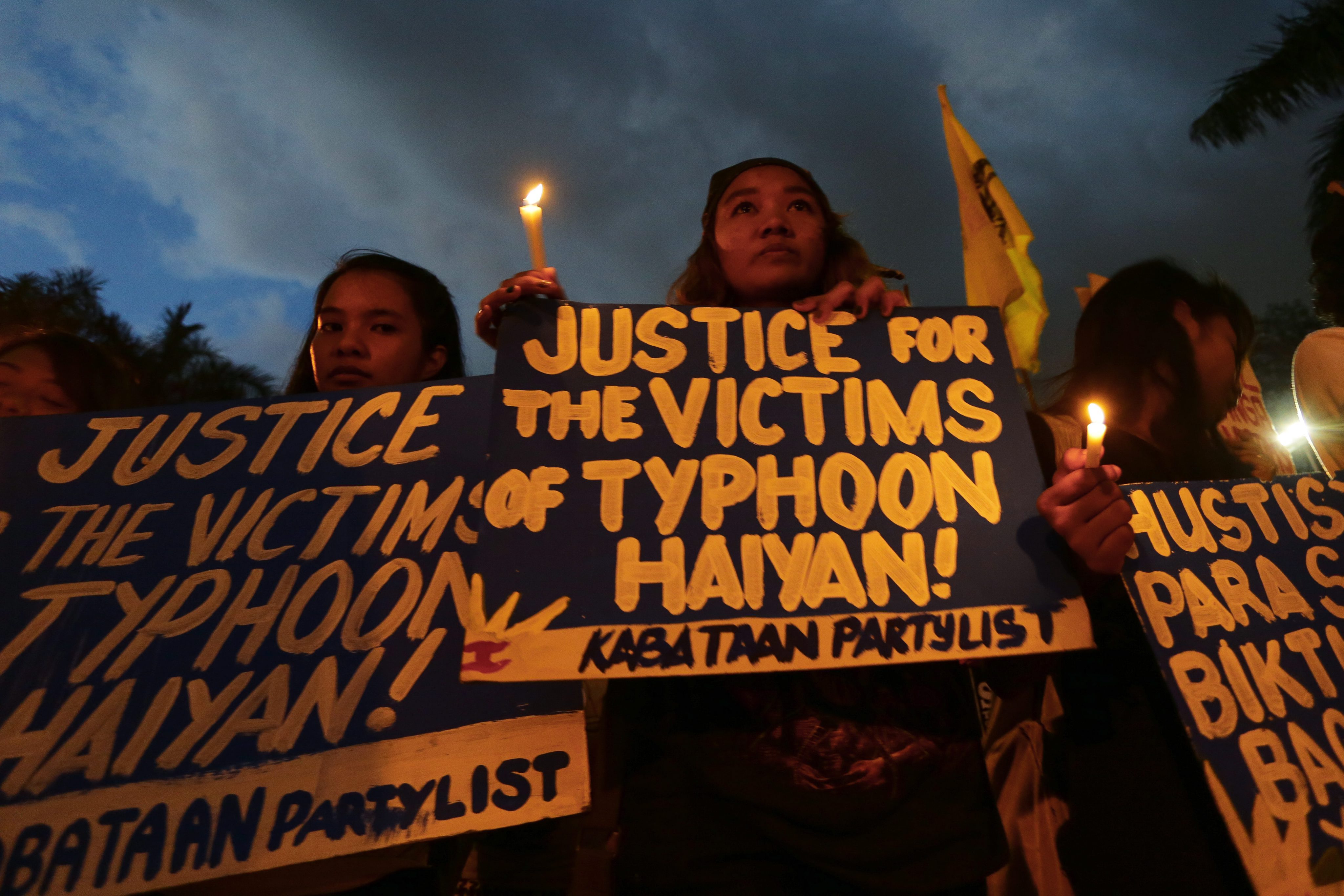 epa05015444 Filipino students hold a candle light vigil for the victims of typhoon Haiyan in Manila, Philippines, 07 November 2015. According to a press statement from the protesting youth group, the demonstration was held to denounce the Government’s protracted rehabilitation Haiyan hit the country November 2013, killing more than 6,300 people. Haiyan also displaced more than four million people wiping out entire villages in the central Philippines. EPA/MARK R. CRISTINO